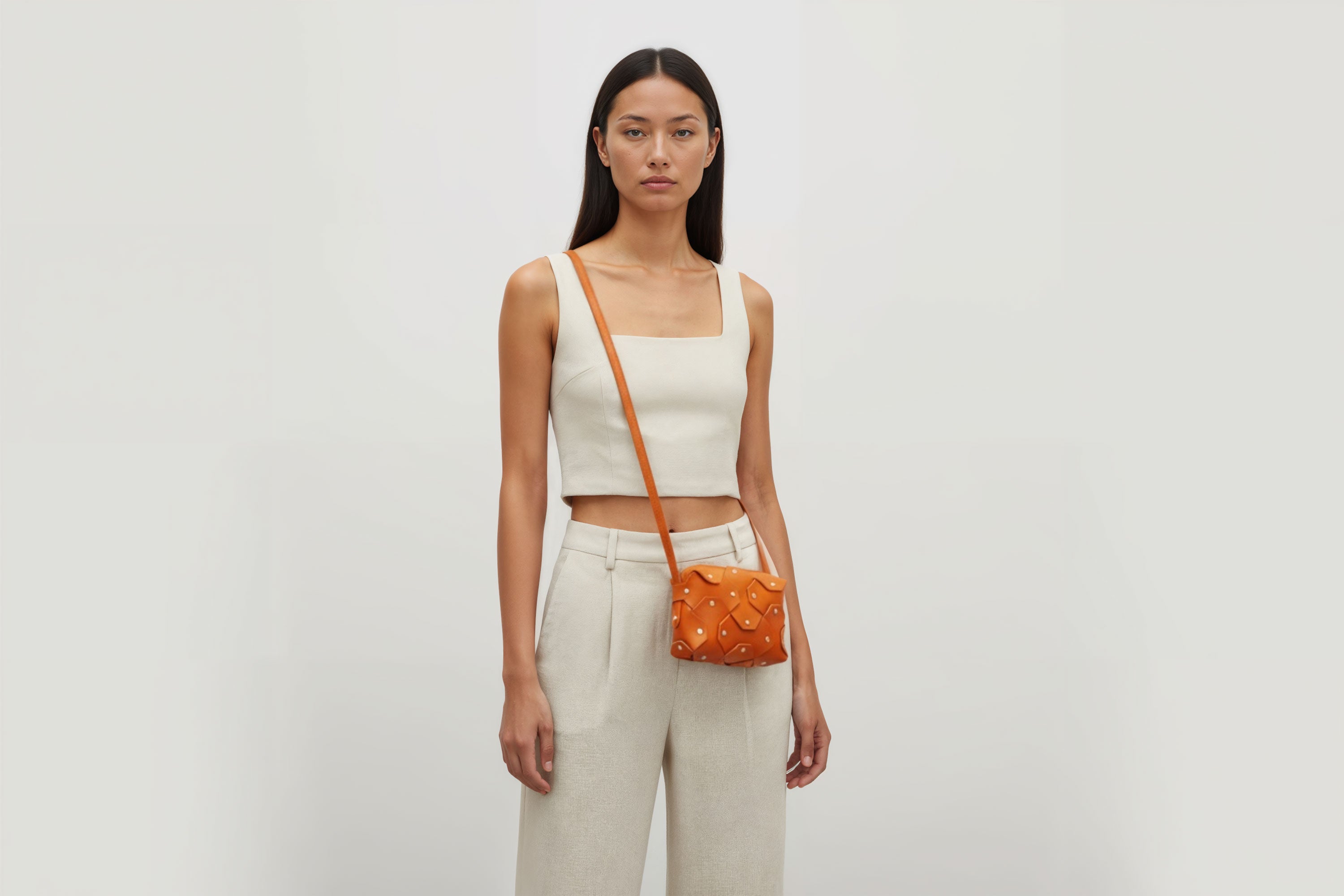 Rivet Bag Small Leather Orange Color Clutch Crossbody On Model Shoulder Detachable Full Brass Vegetable Tanned Full Grain Leather High Quality Modern Minimalistic Design Atelier Madre Manuel Dreesmann Barcelona Spain