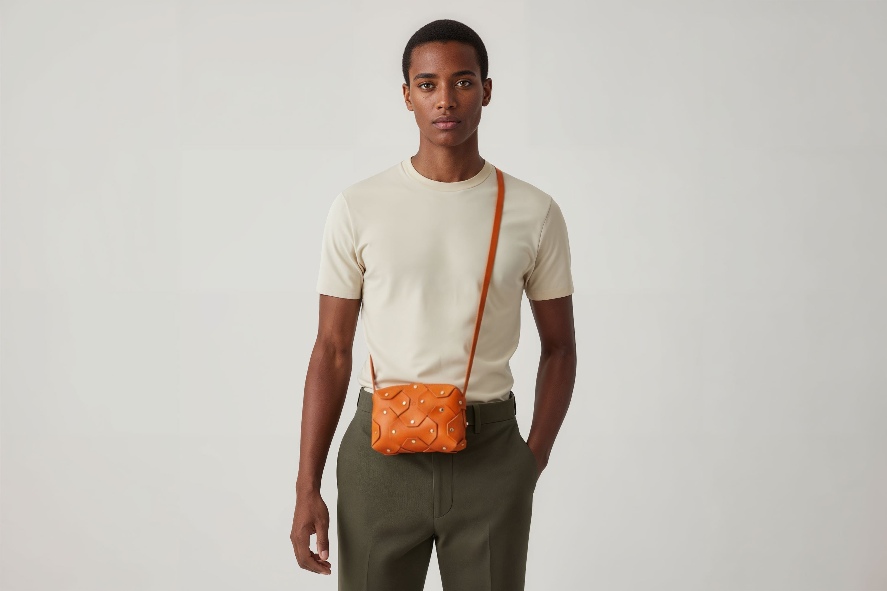 Rivet Bag Small Leather Orange Color Clutch Crossbody On Model Shoulder Detachable Full Brass Vegetable Tanned Full Grain Leather High Quality Modern Minimalistic Design Atelier Madre Manuel Dreesmann Barcelona Spain