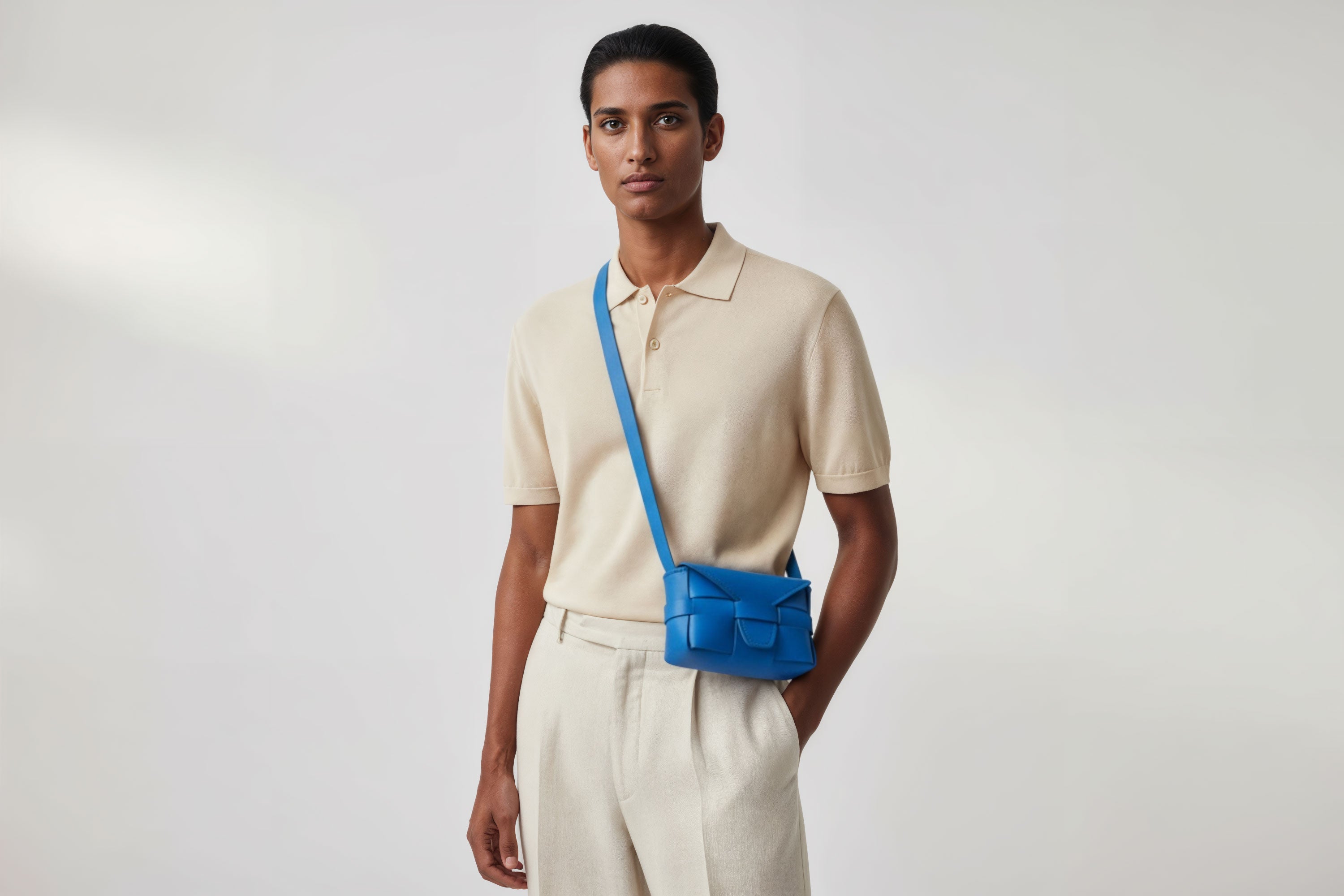Man wearing the royal blue small Saka leather bag against a plain background. Minimalist design from Atelier Madre - Manuel Dreesmann in Barcelona