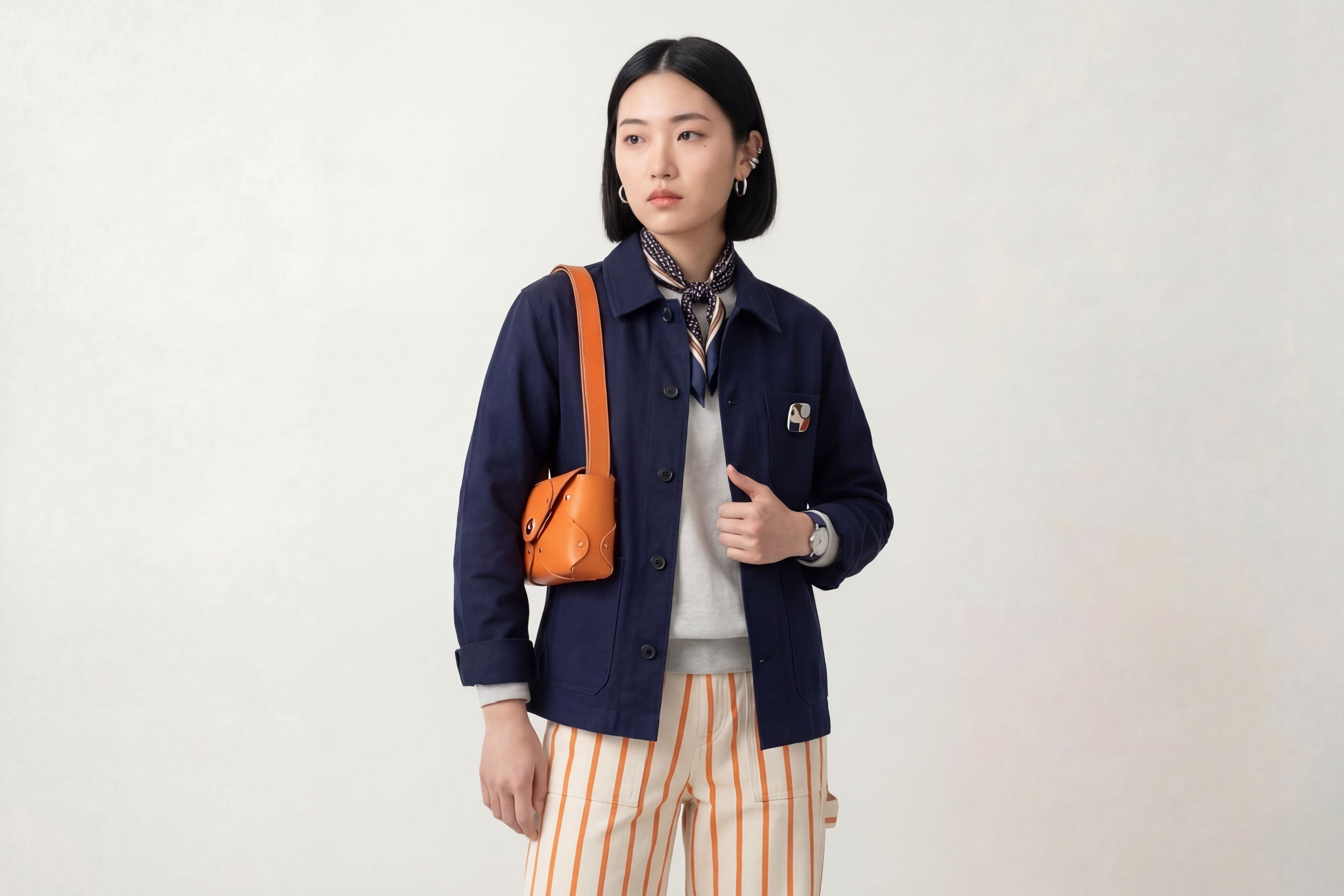 Tamara Bag Orange Color On A Woman Model Leather Vegetable Tanned Leather Minimalist Modern Design Rivets Brass Premium Shoulderbag Atelier Madre Manuel Dreesmann Barcelona Spain