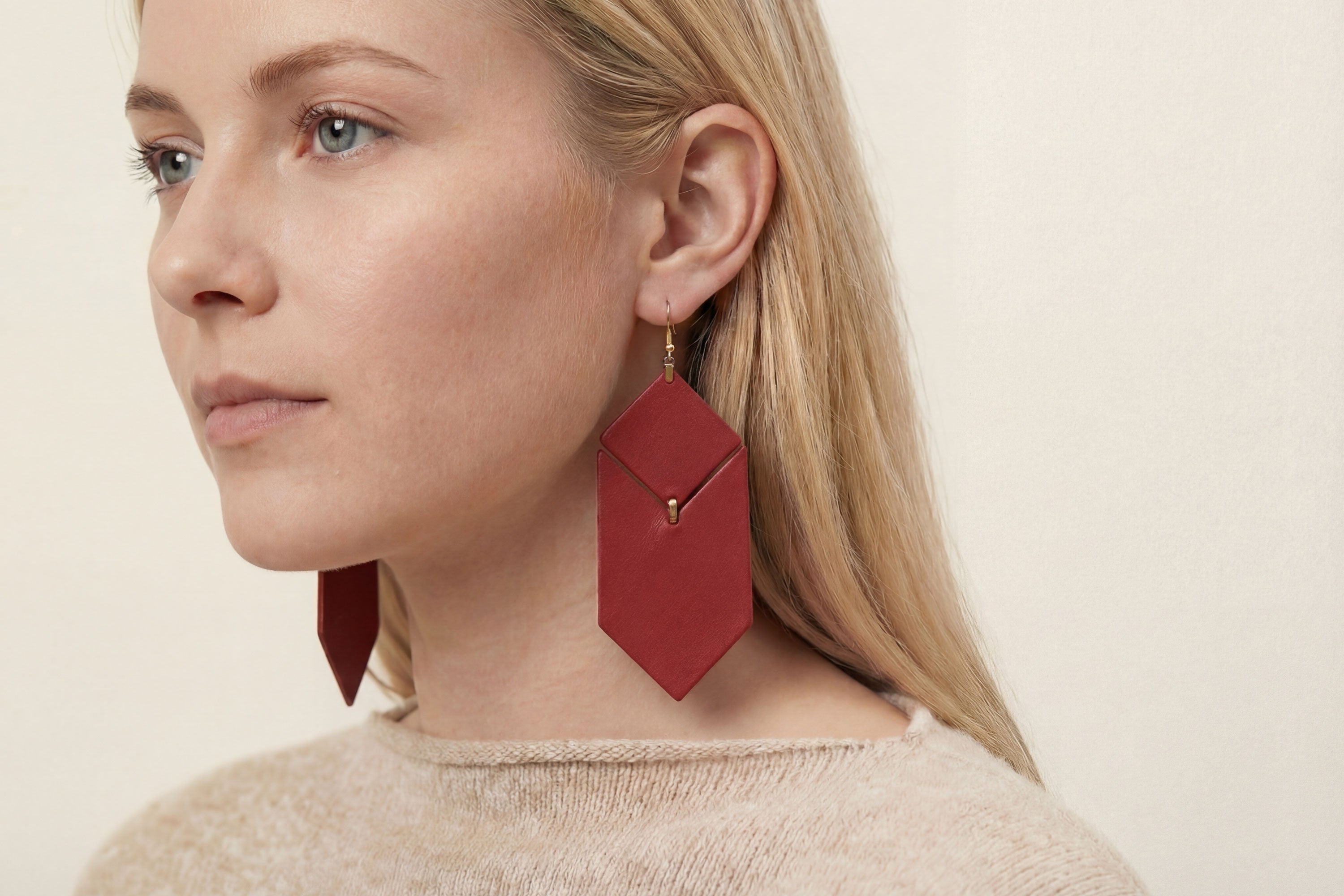 Tess Earrings Leather In Red Color On Model Vegetable Tanned Leather Minimalistic Design Atelier Madre Manuel Dreesmann Barcelona Spain