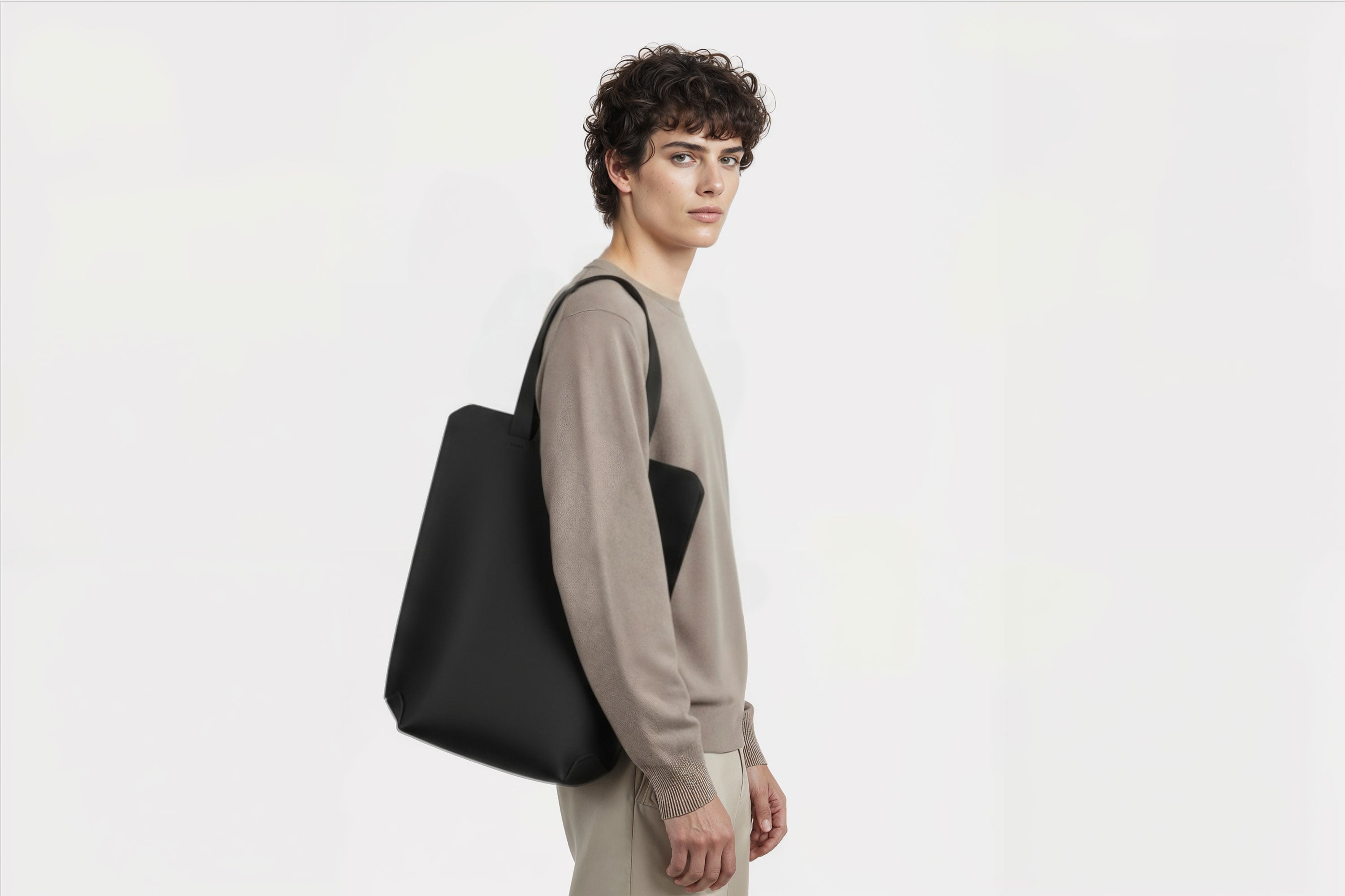 Tote Bag Long Black Color Leather Bag On A Man Model Vegetable Tanned Leather Exclusive Quality Craftsmanship Handmade Design By Manuel Dreesmann Atelier Madre Barcelona Spain