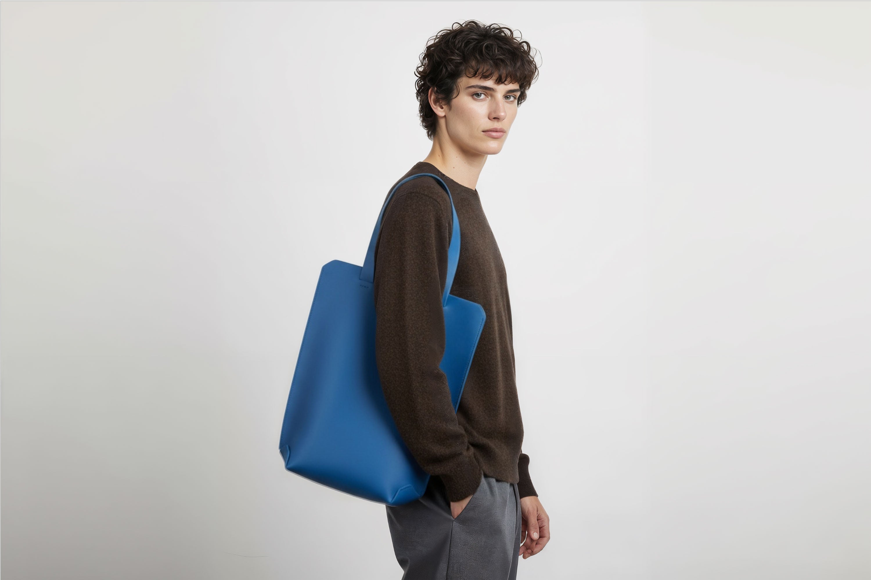 Tote Bag Long Royal Blue Leather Bag On A Man Model Vegetable Tanned Leather Exclusive Quality Craftsmanship Handmade Design By Manuel Dreesmann Atelier Madre Barcelona Spain