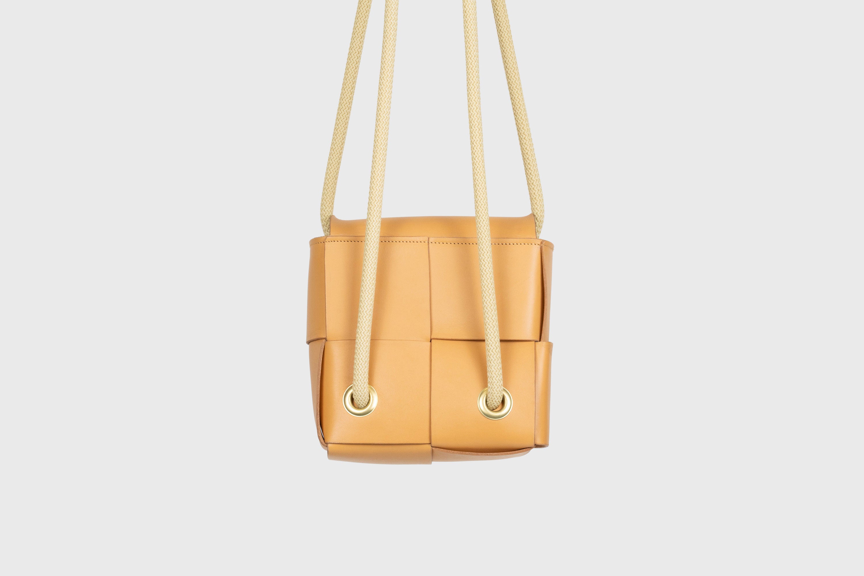 Elegant Atelier Madre Brown woven leather backpack, designed by Manuel Dreesmann, showcasing exquisite craftsmanship and luxury style, crafted in the heart of Barcelona.