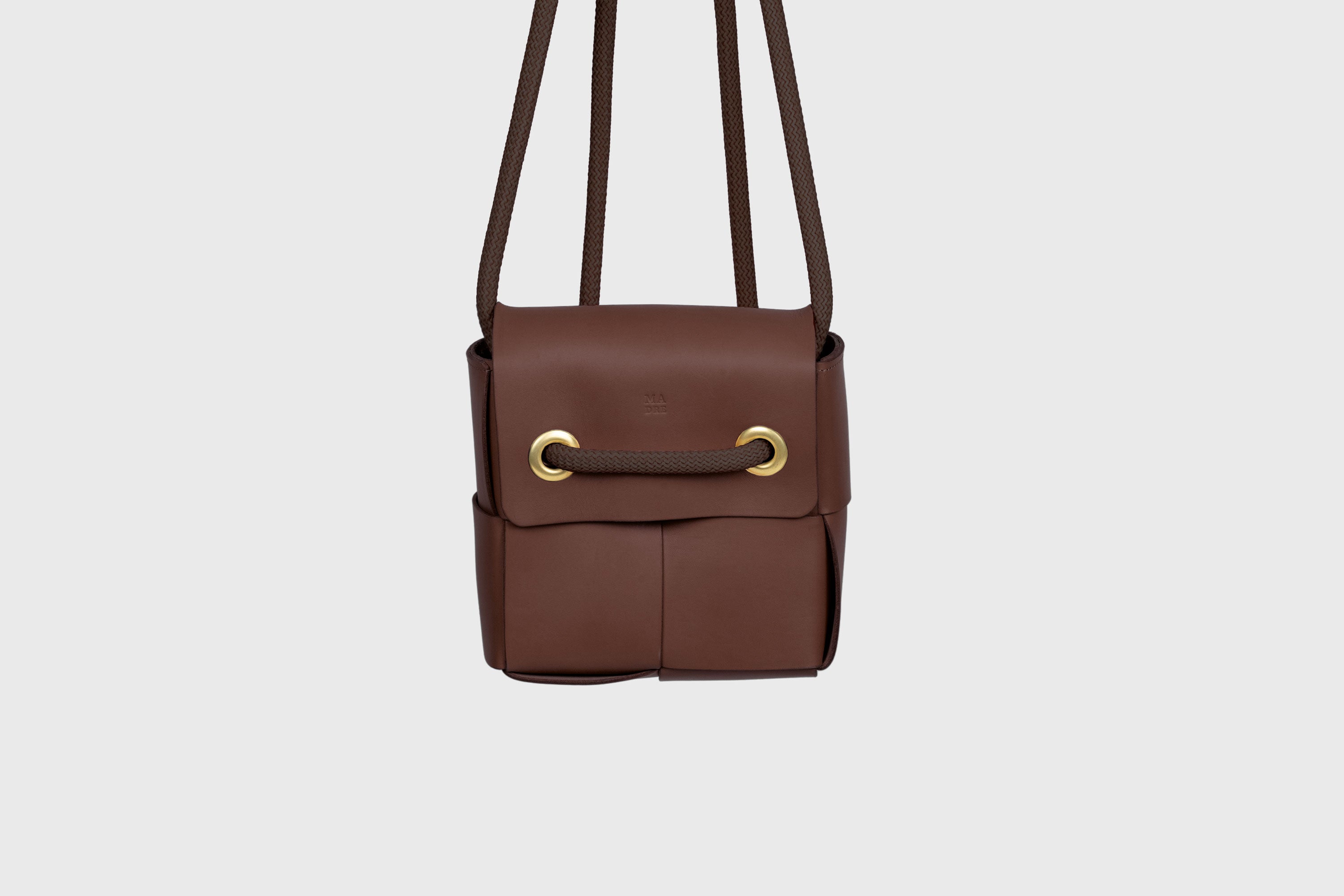 Elegant Atelier Madre Dark Brown Color woven leather backpack, designed by Manuel Dreesmann, showcasing exquisite craftsmanship and luxury style, crafted in the heart of Barcelona.