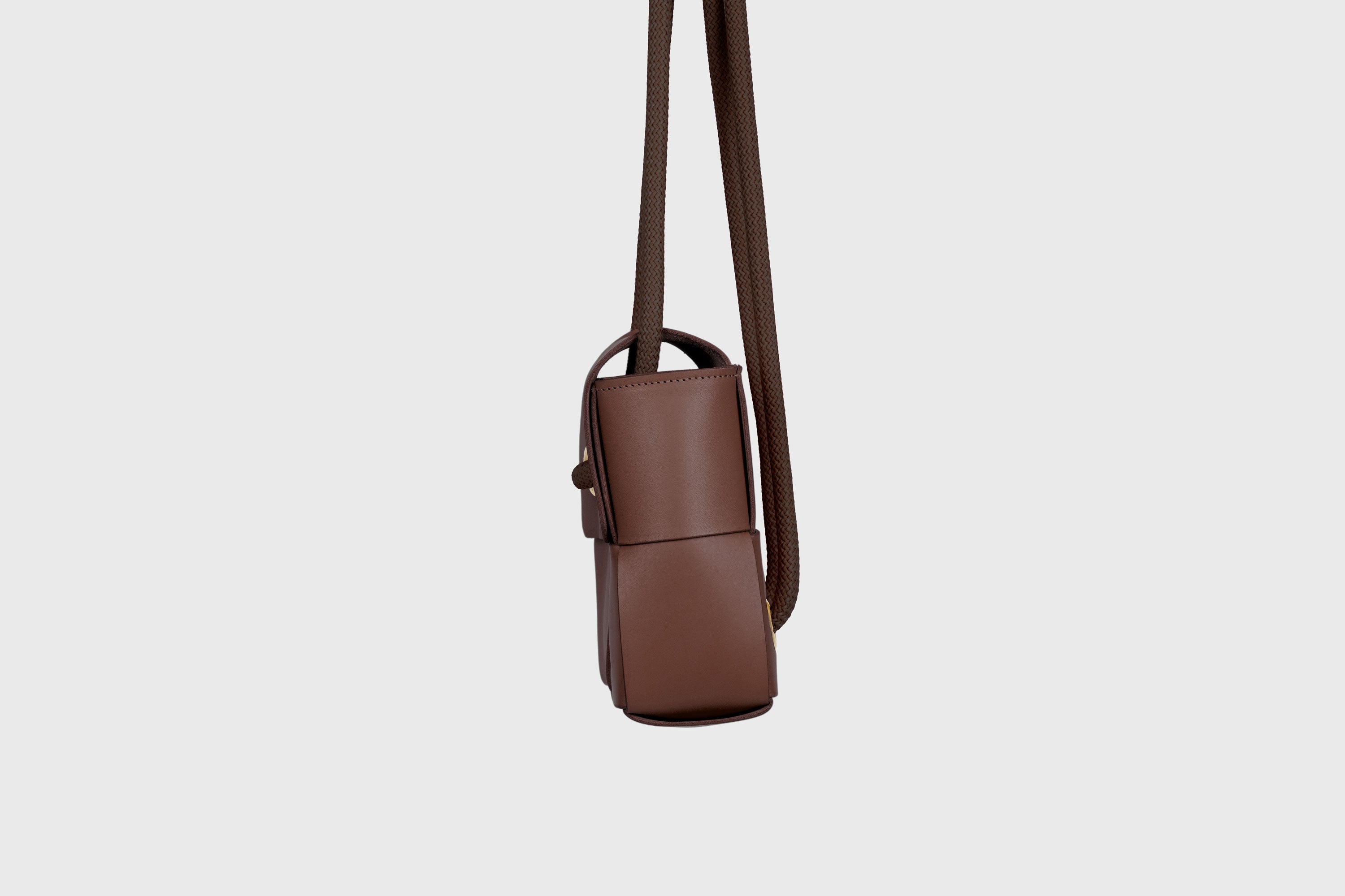 Elegant Atelier Madre Dark Brown Color woven leather backpack, designed by Manuel Dreesmann, showcasing exquisite craftsmanship and luxury style, crafted in the heart of Barcelona.