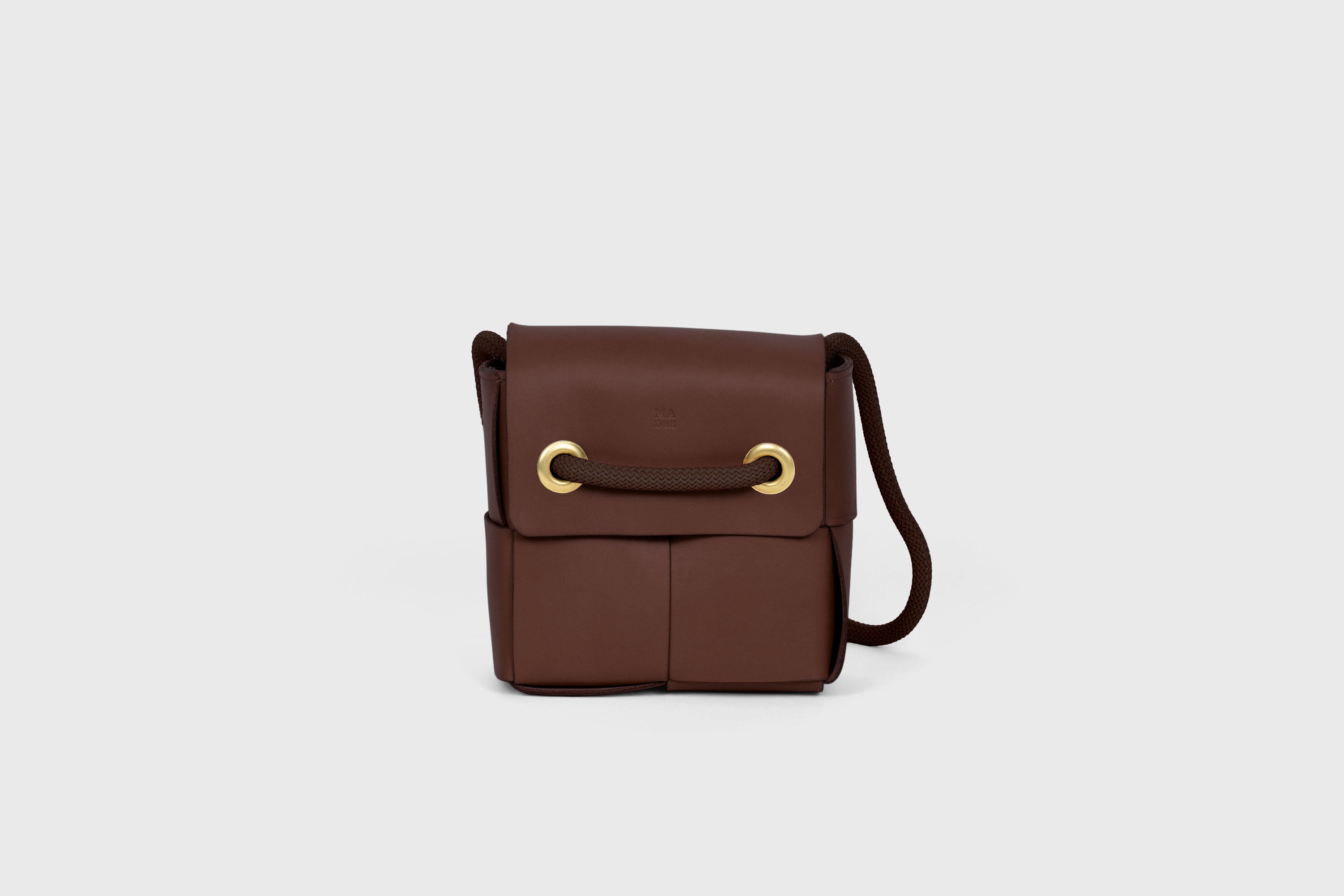 Elegant Atelier Madre Dark Brown Color woven leather backpack, designed by Manuel Dreesmann, showcasing exquisite craftsmanship and luxury style, crafted in the heart of Barcelona.