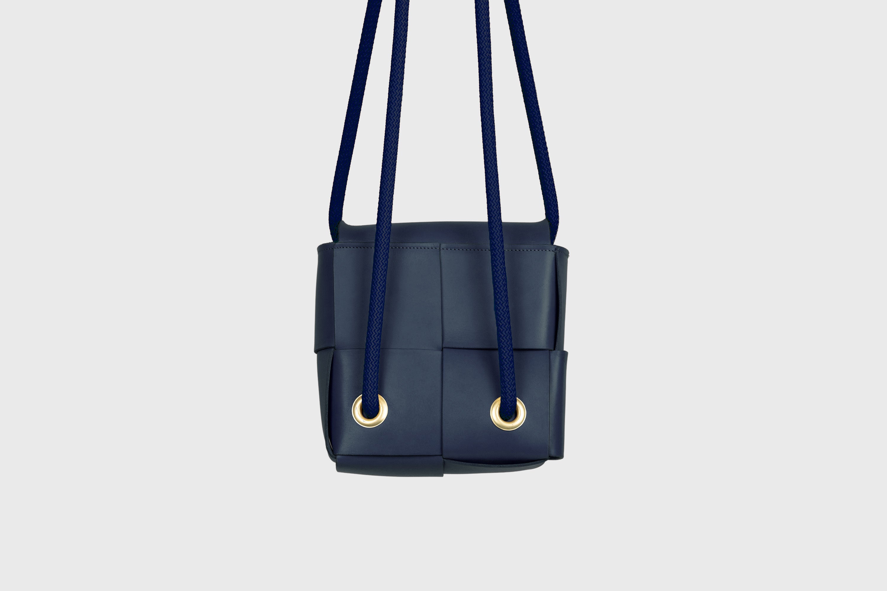 Elegant Atelier Madre Marine Blue Color woven leather backpack, designed by Manuel Dreesmann, showcasing exquisite craftsmanship and luxury style, crafted in the heart of Barcelona.