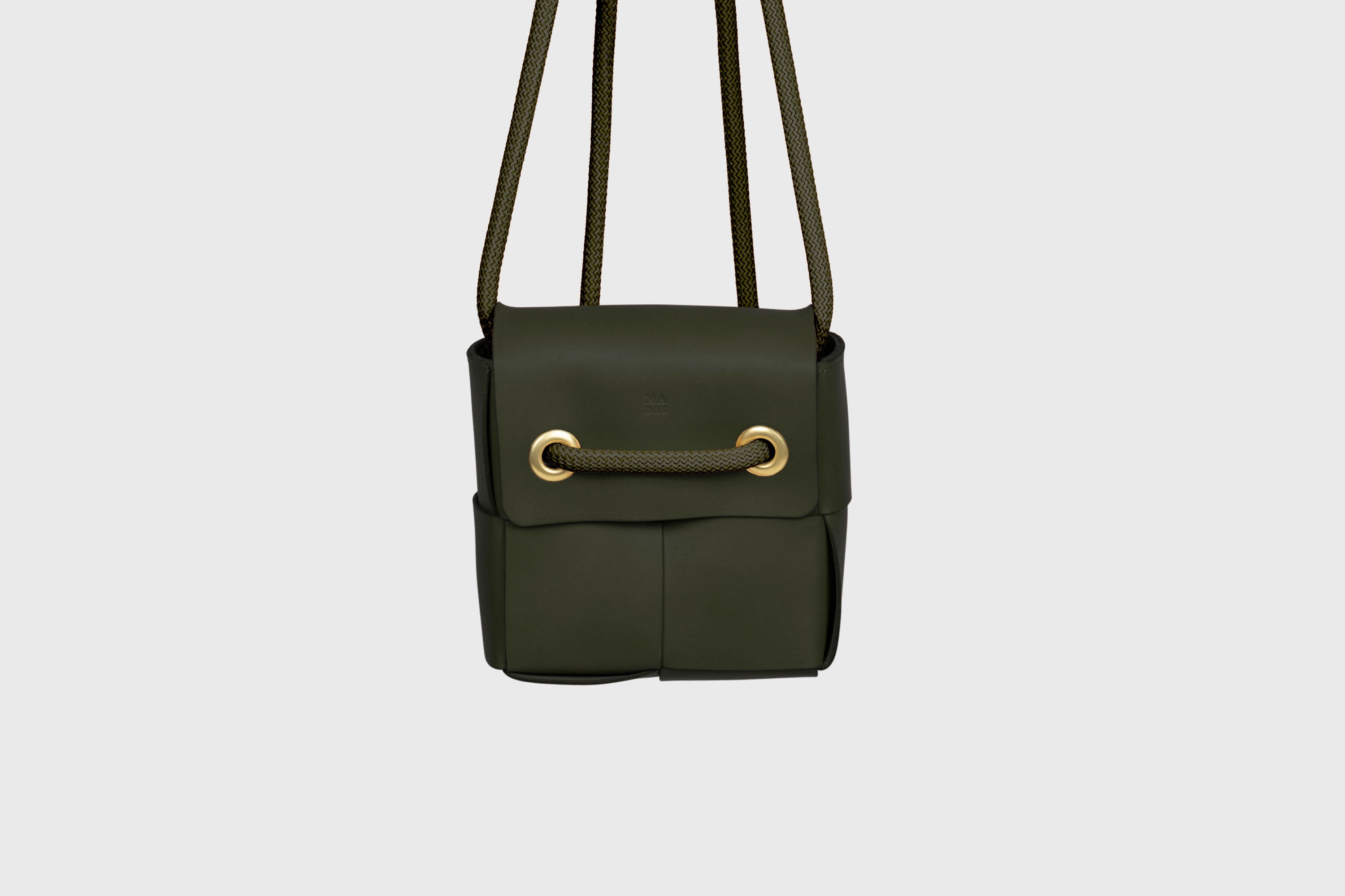 Elegant Atelier Madre Olive Green Color woven leather backpack, designed by Manuel Dreesmann, showcasing exquisite craftsmanship and luxury style, crafted in the heart of Barcelona.