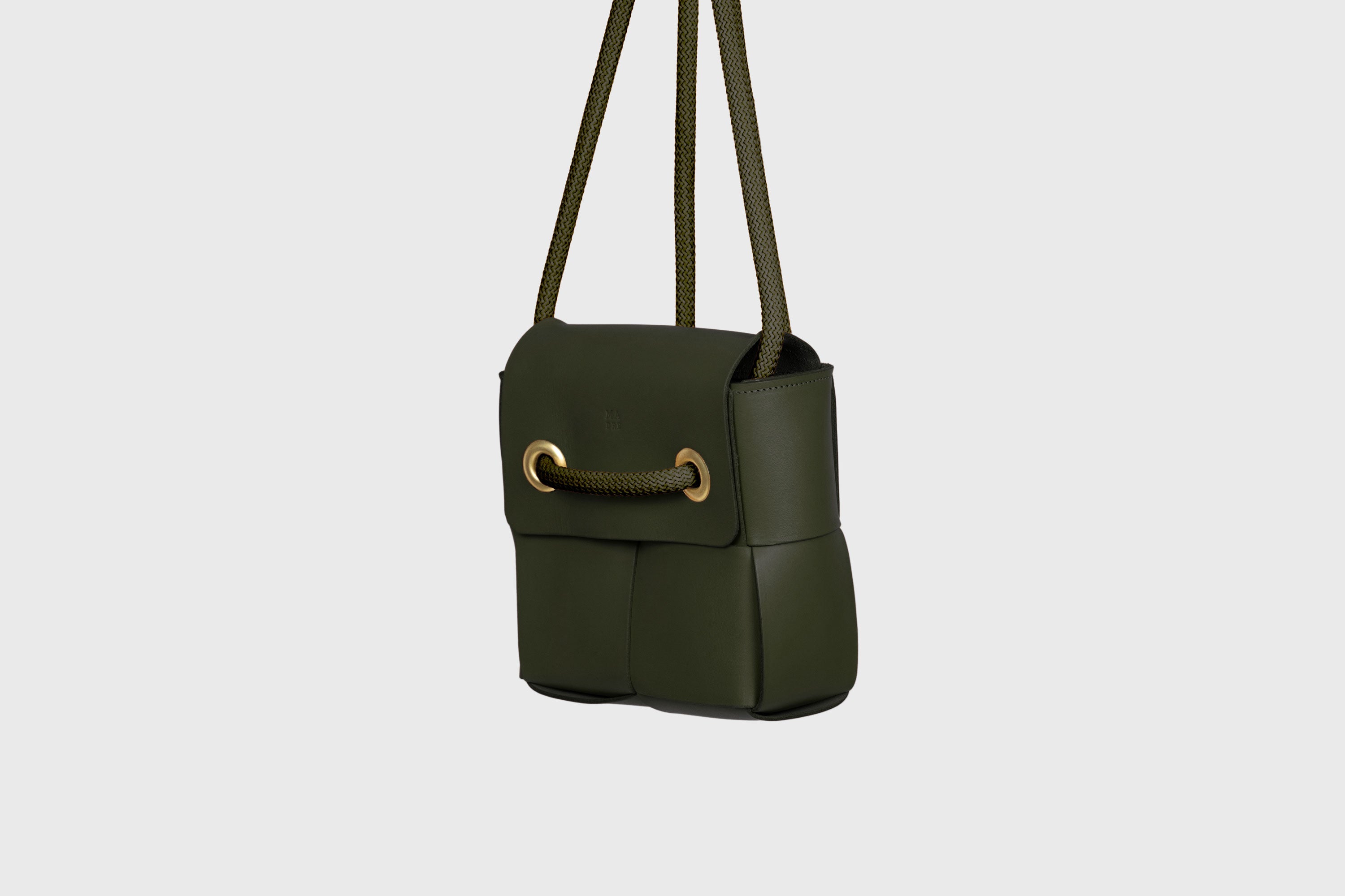 Elegant Atelier Madre Olive Green Color woven leather backpack, designed by Manuel Dreesmann, showcasing exquisite craftsmanship and luxury style, crafted in the heart of Barcelona.