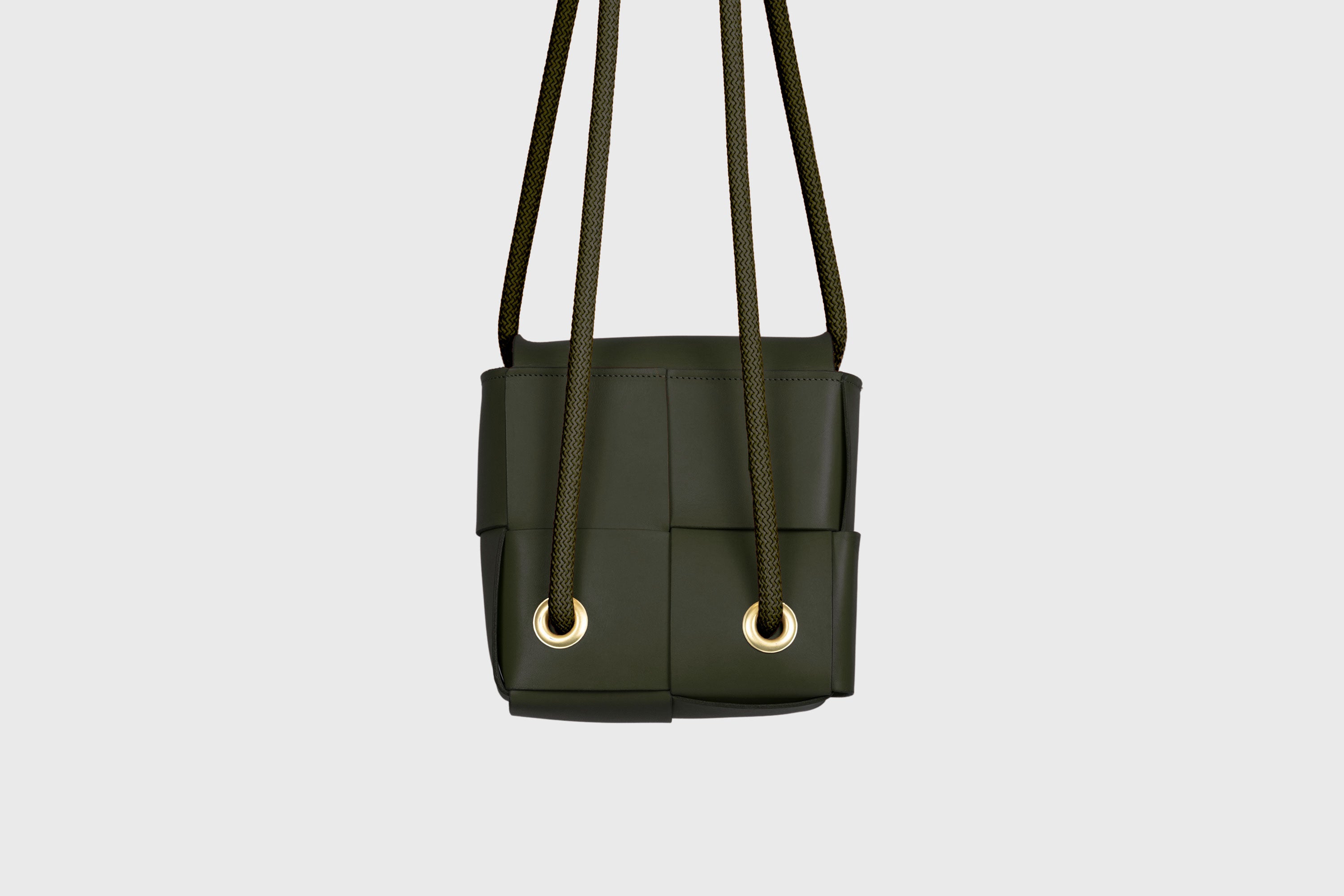 Elegant Atelier Madre Olive Green Color woven leather backpack, designed by Manuel Dreesmann, showcasing exquisite craftsmanship and luxury style, crafted in the heart of Barcelona.