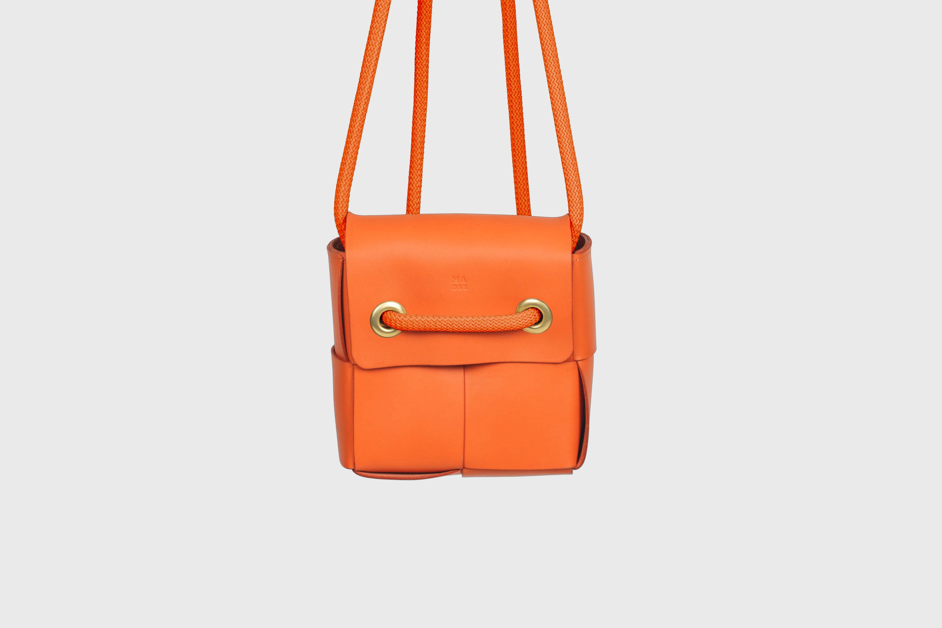 Elegant Atelier Madre Orange Color woven leather backpack, designed by Manuel Dreesmann, showcasing exquisite craftsmanship and luxury style, crafted in the heart of Barcelona.