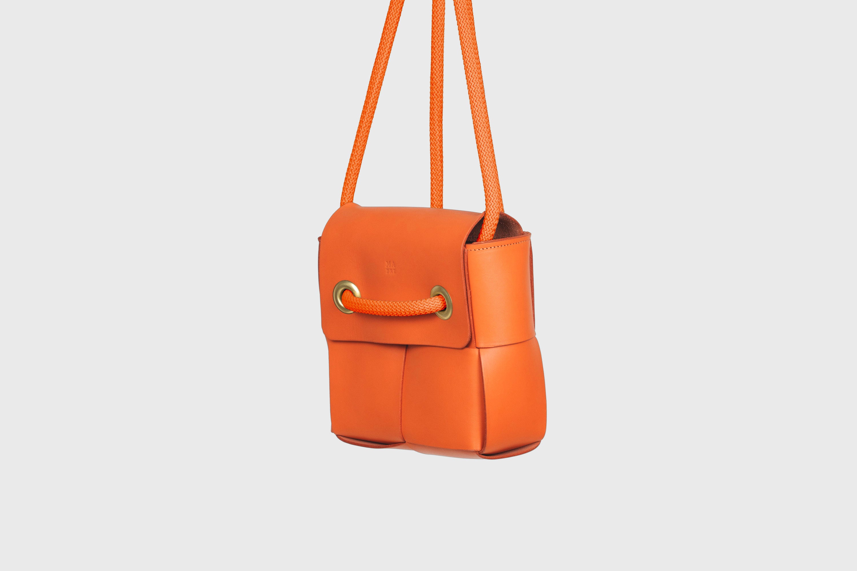 Elegant Atelier Madre Orange Color woven leather backpack, designed by Manuel Dreesmann, showcasing exquisite craftsmanship and luxury style, crafted in the heart of Barcelona.