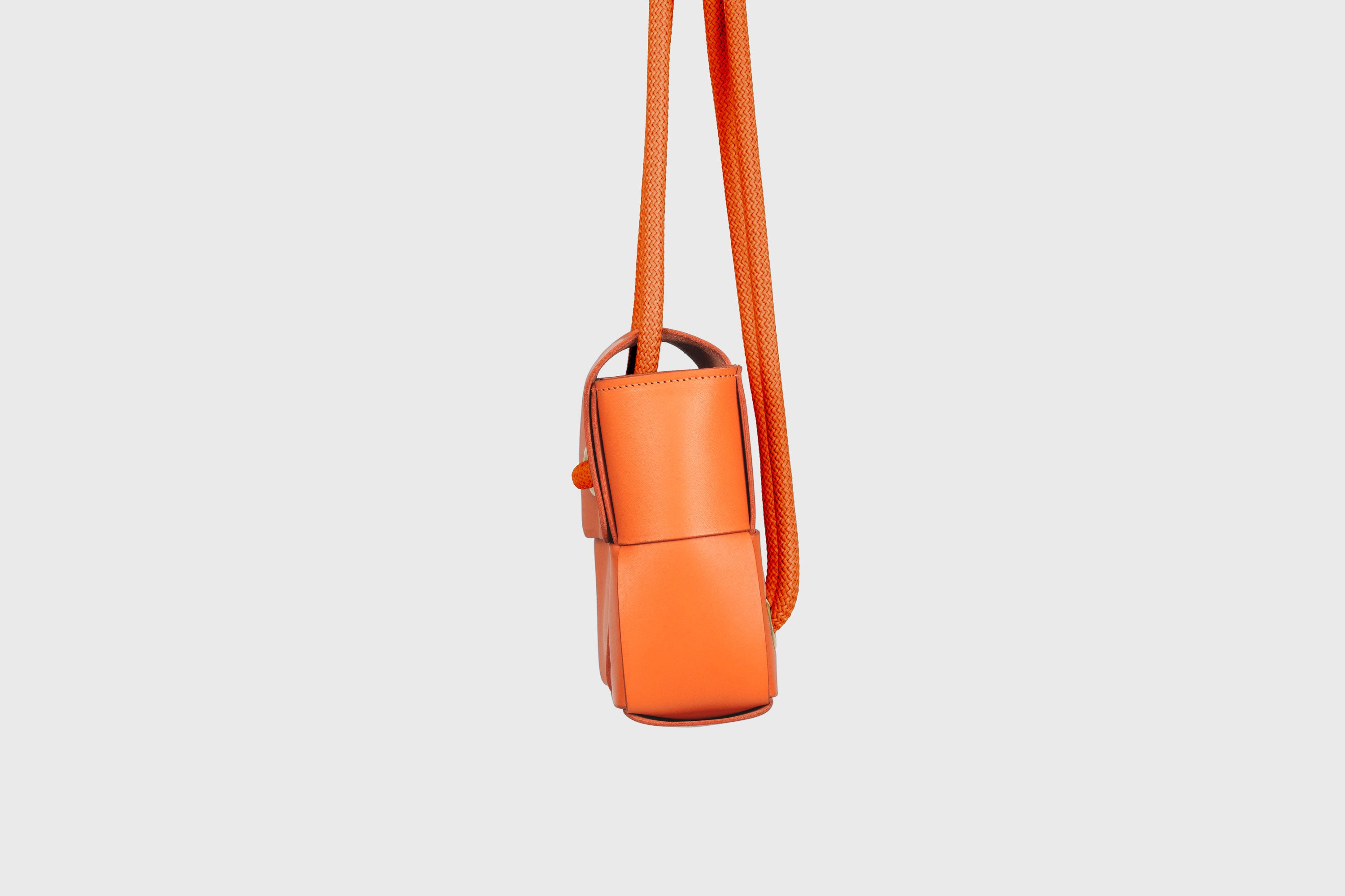 Elegant Atelier Madre Orange Color woven leather backpack, designed by Manuel Dreesmann, showcasing exquisite craftsmanship and luxury style, crafted in the heart of Barcelona.