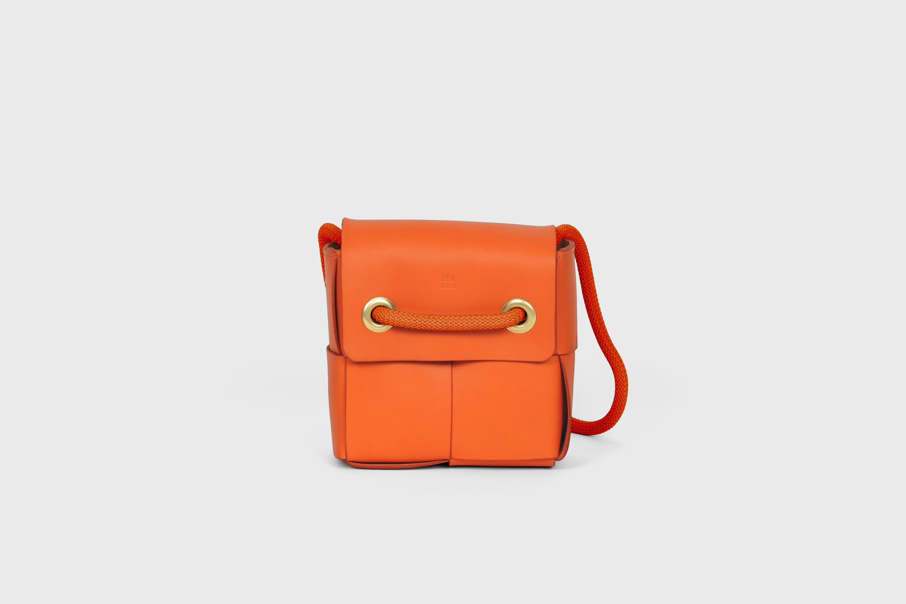 Elegant Atelier Madre Orange Color woven leather backpack, designed by Manuel Dreesmann, showcasing exquisite craftsmanship and luxury style, crafted in the heart of Barcelona.