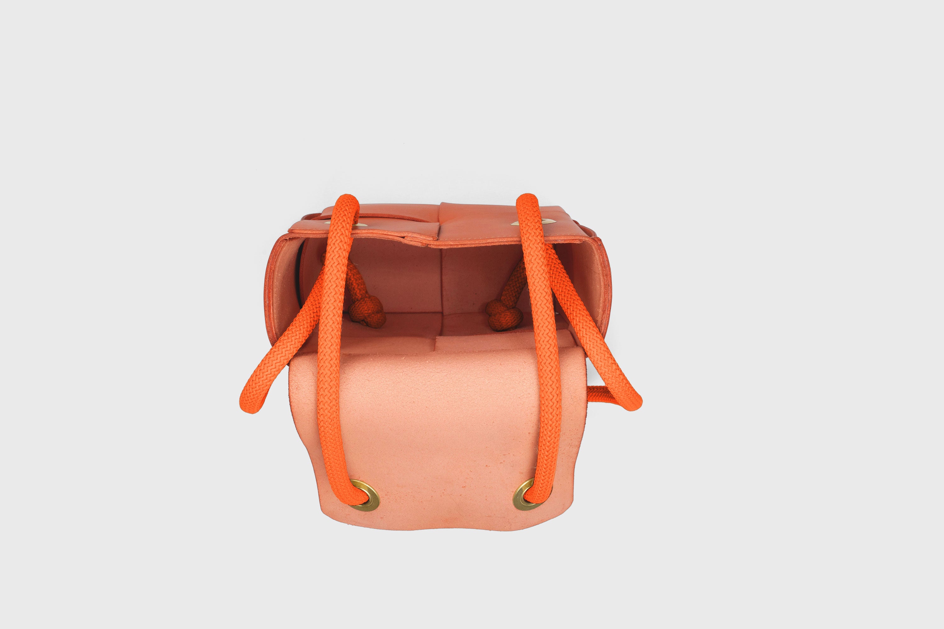 Elegant Atelier Madre Orange Color woven leather backpack, designed by Manuel Dreesmann, showcasing exquisite craftsmanship and luxury style, crafted in the heart of Barcelona.