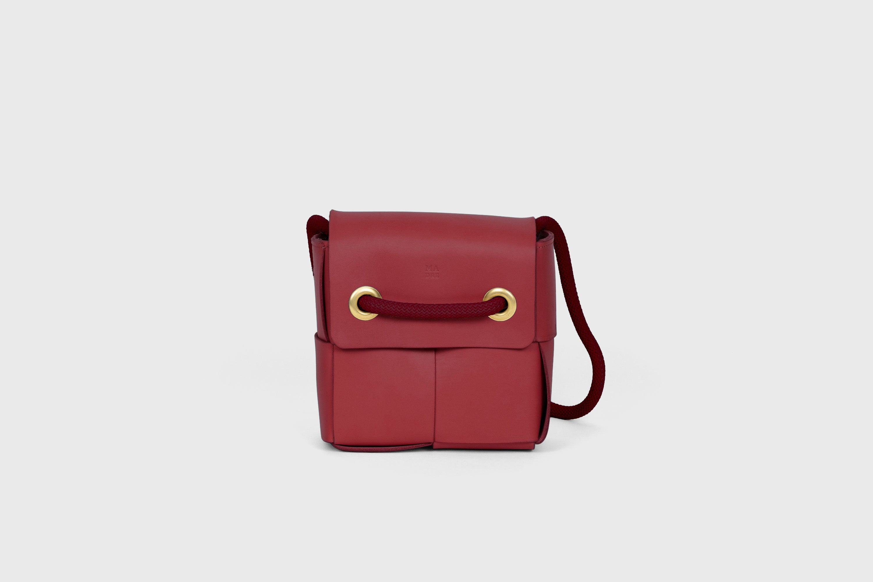 Elegant Atelier Madre Red Color woven leather backpack, designed by Manuel Dreesmann, showcasing exquisite craftsmanship and luxury style, crafted in the heart of Barcelona.