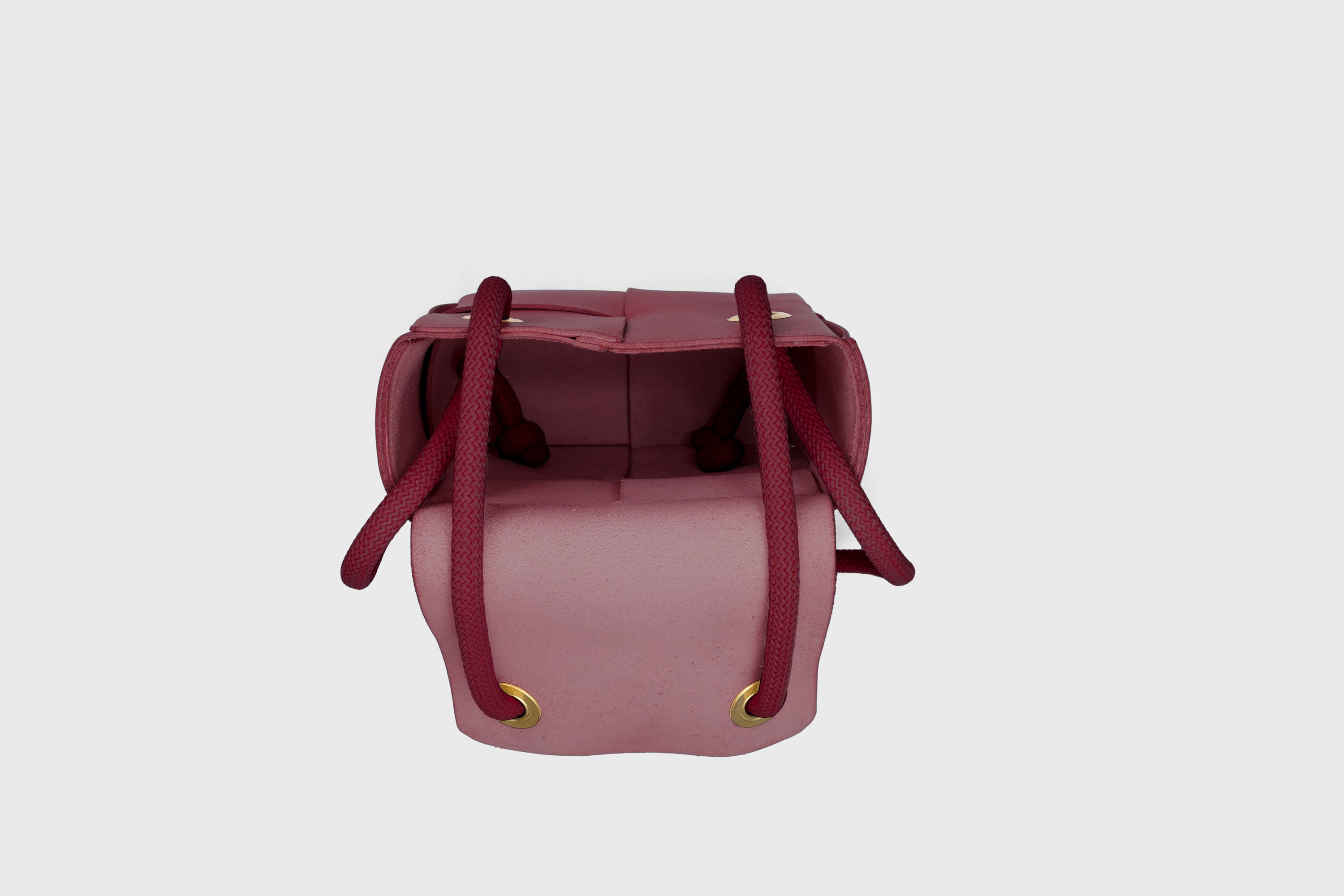 Elegant Atelier Madre Red Color woven leather backpack, designed by Manuel Dreesmann, showcasing exquisite craftsmanship and luxury style, crafted in the heart of Barcelona.