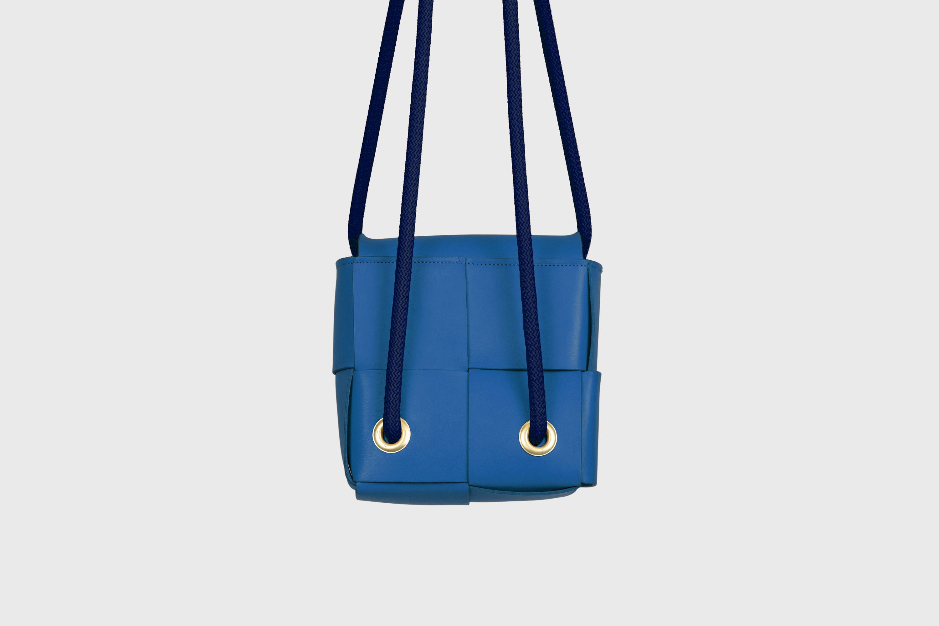 Elegant Atelier Madre Royal Blue Color woven leather backpack, designed by Manuel Dreesmann, showcasing exquisite craftsmanship and luxury style, crafted in the heart of Barcelona.