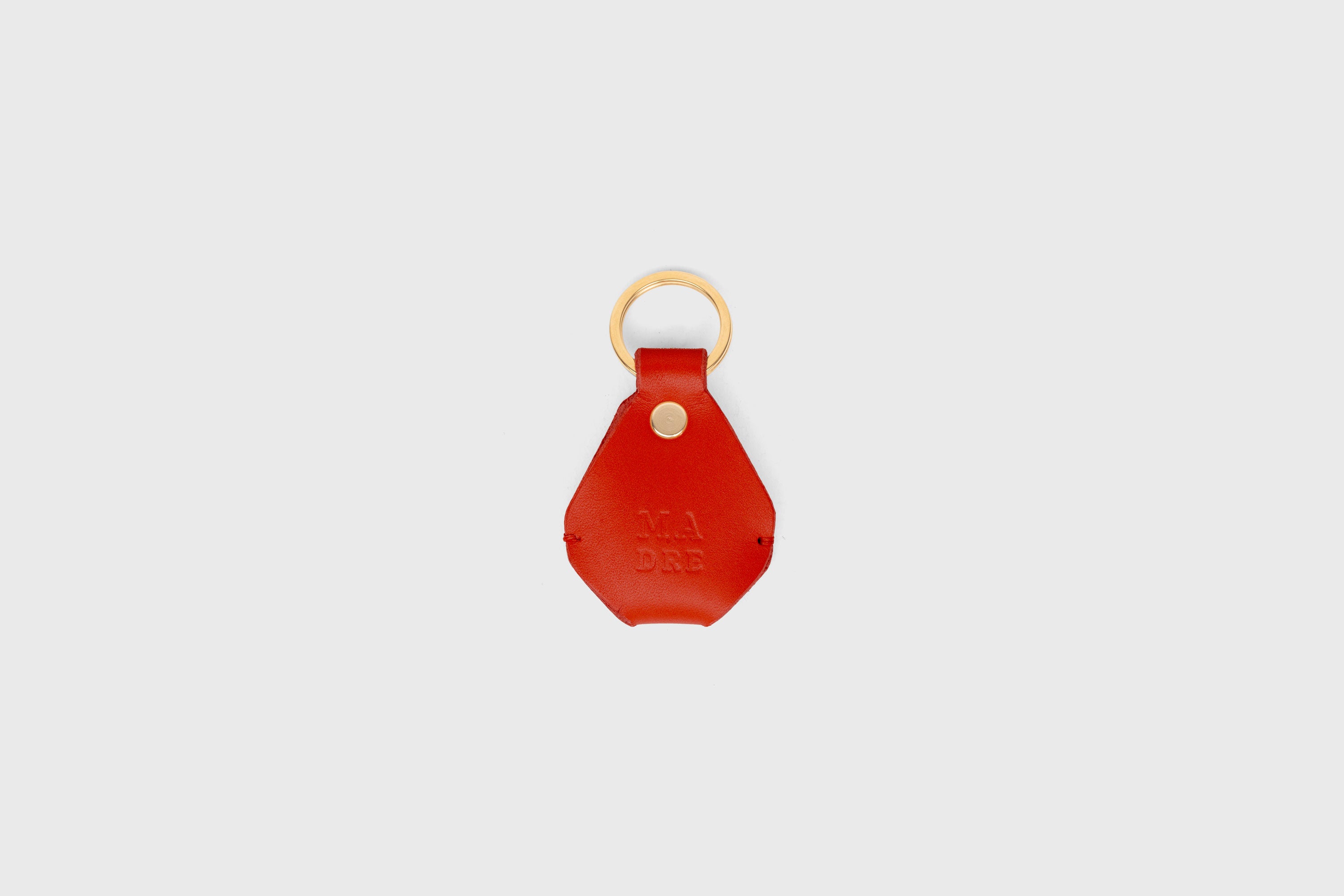 Airtag Key Ring In Red Color In Vegetable Tanned Leather Minimalistic Design Atelier Madre Manuel Dreesmann Barcelona Spain