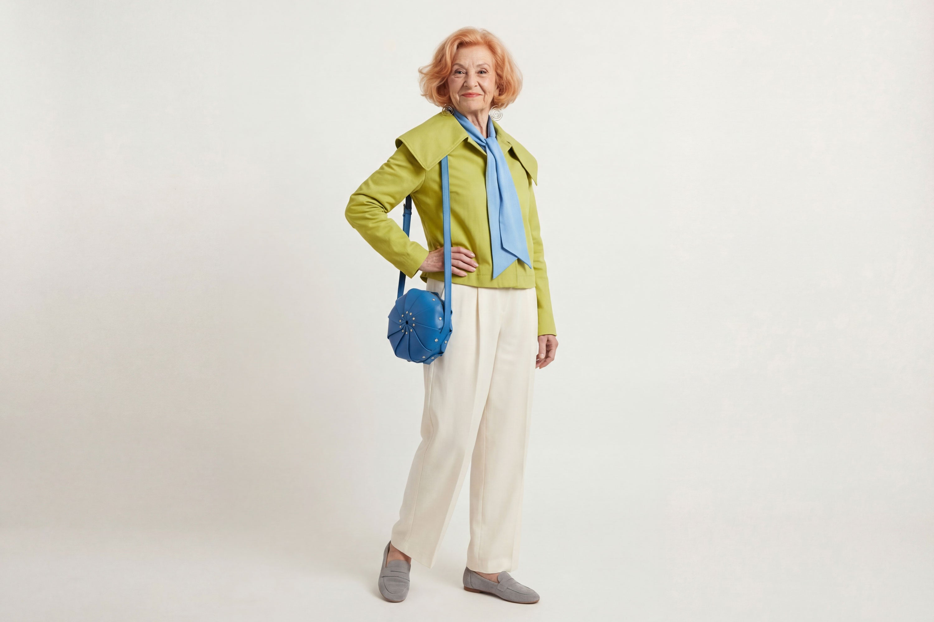 Anemo Leather Bag Royal Blue Color On A Woman Model Floral Design Premium Minimalist Modern Circle Round Pouch Crossbody Atelier Madre Manuel Dreesmann Barcelona Spain