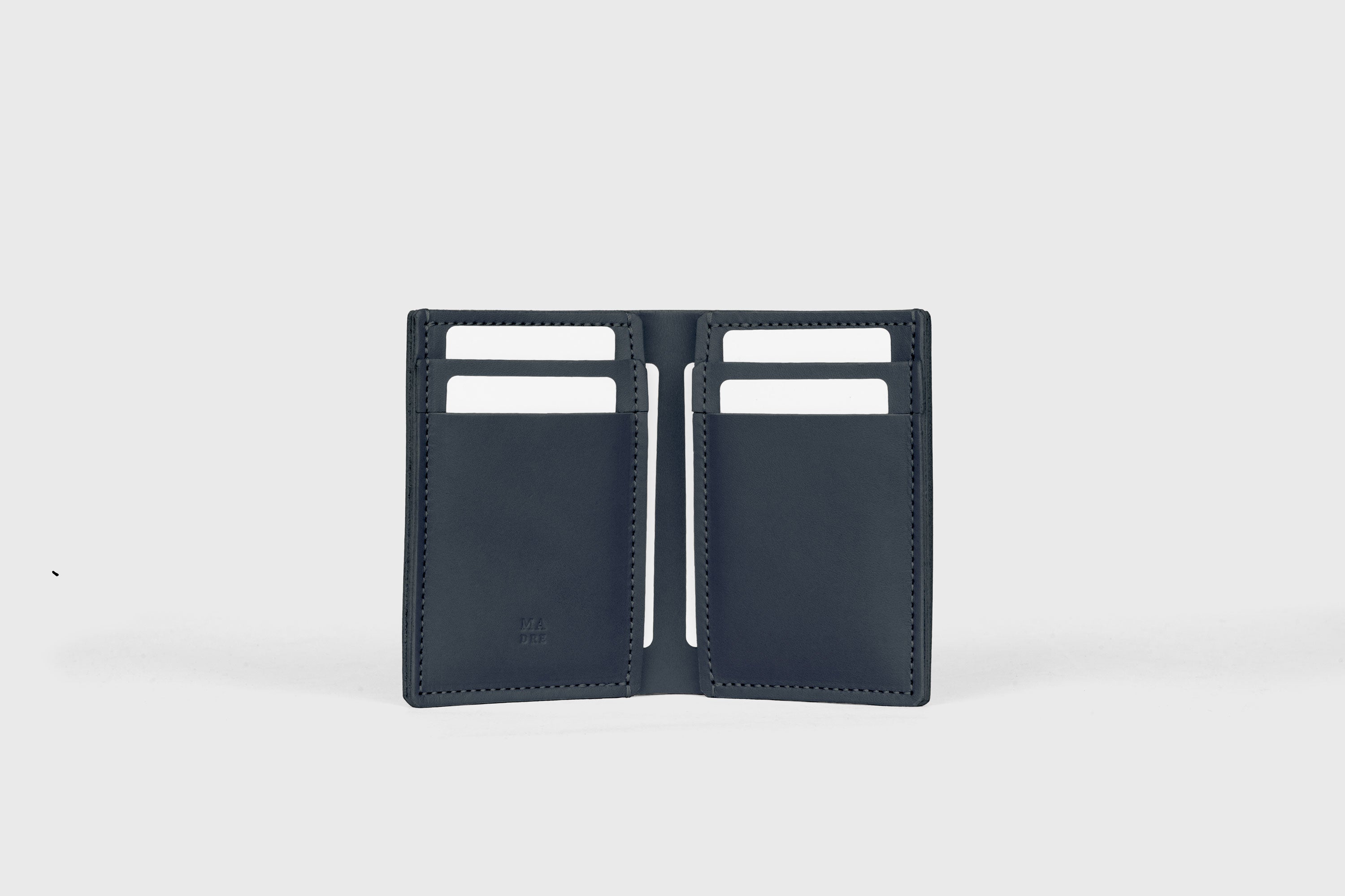 Bifold Wallet Vertical 6 Slots In Marine Blue Color In Vegetable Tanned Leather Minimalistic Design Atelier Madre Manuel Dreesmann Barcelona Spain