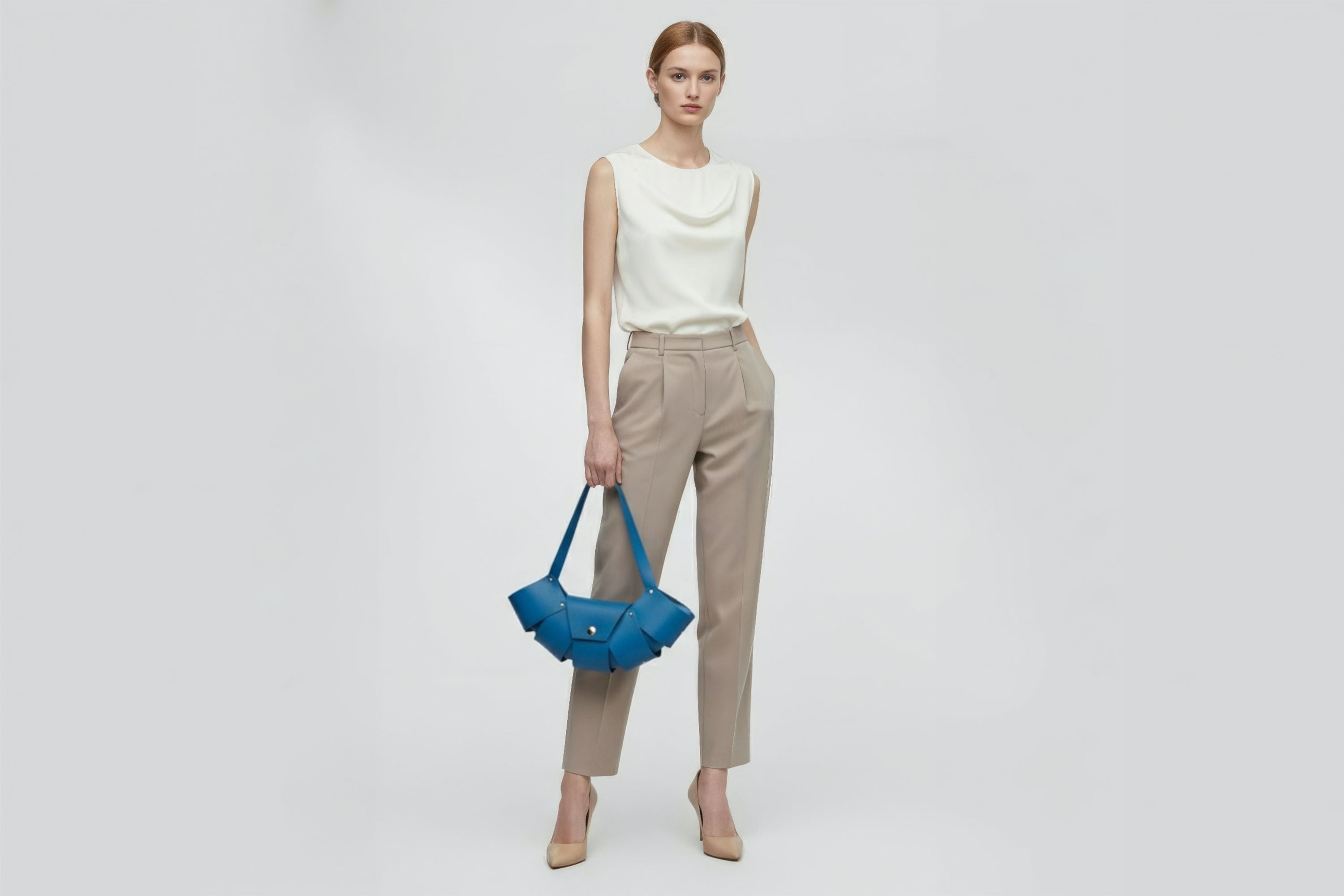 Croissant Bag Big Royal Blue Colour Leather Magnetic Closure On A Woman Model Full Grain Vegetable Tanned Leather High Quality Modern Minimalistic Organic Design Full Brass Rivets Atelier Madre Manuel Dreesmann Barcelona Spain