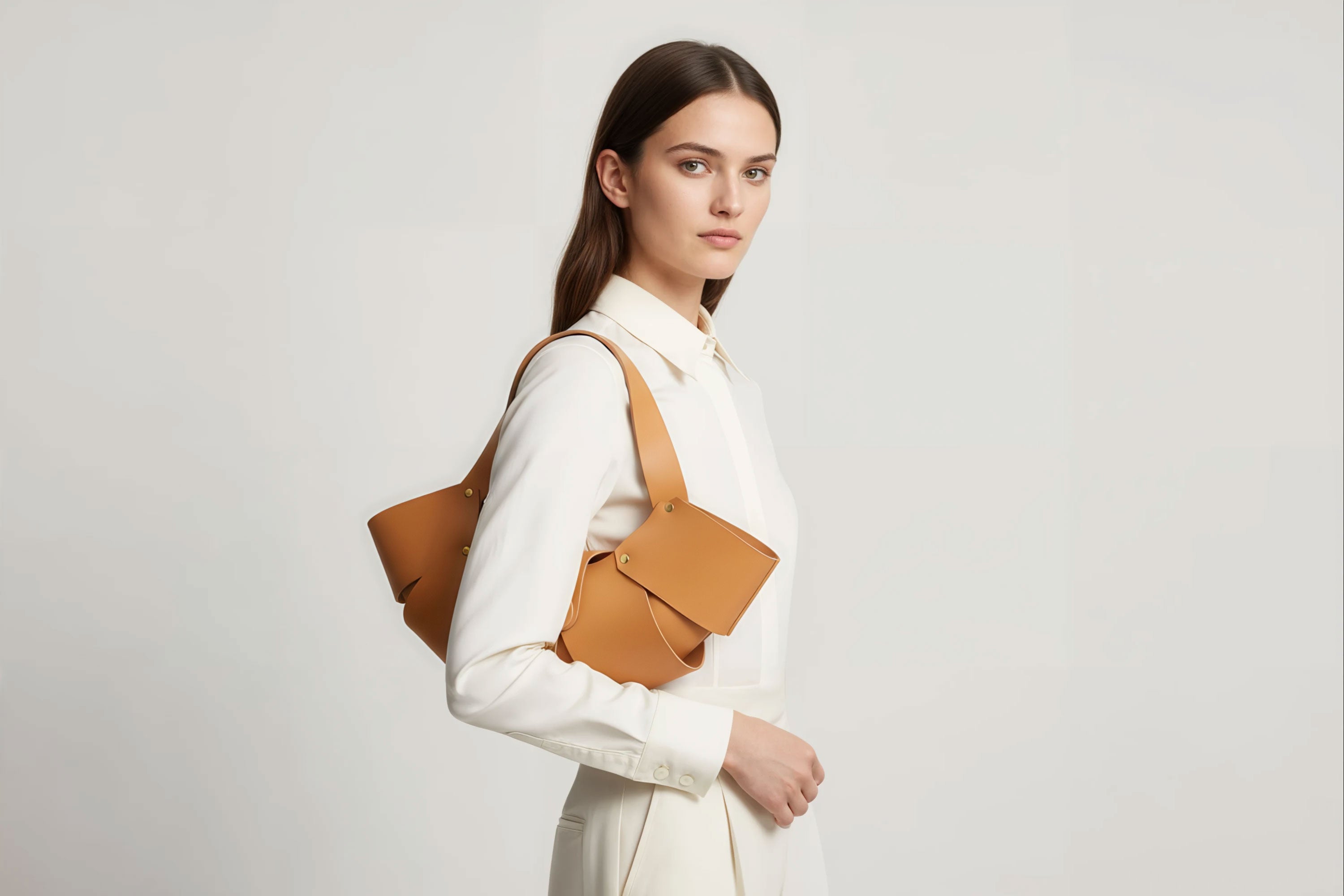 Woman Wearing Croissant Bag Magnetic Leather Brown Close Perspective Minimalistic Design Atelier Madre Manuel Dreesmann-Barcelona