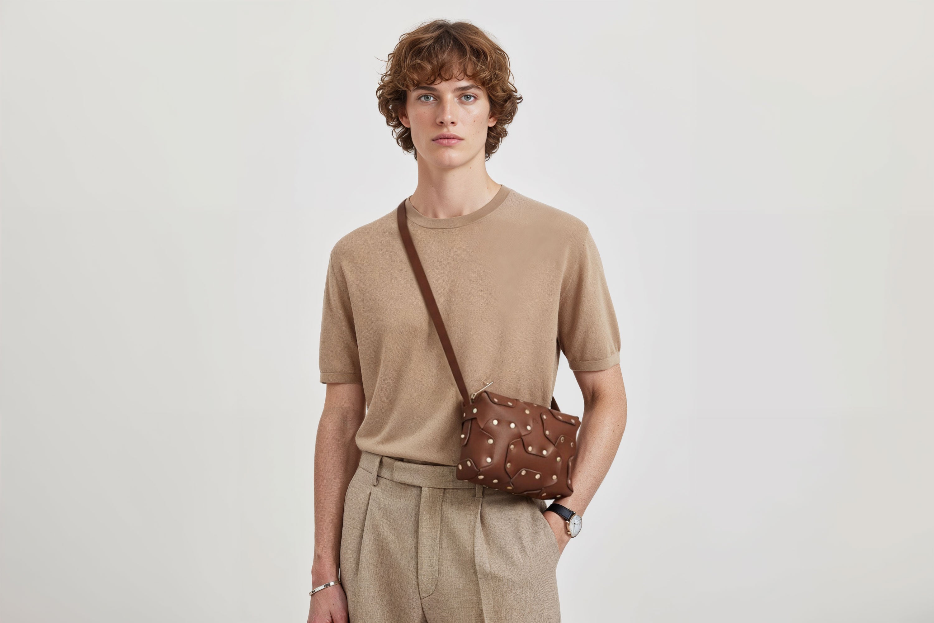 Double Rivet Bag Dark Brown Color On A Man Model Leather Full Grain Vegetable Tanned Leather Modern Minimalist Design Premium Quality Full Brass Clutch Crossbody Shoulder Bag Atelier Madre Manuel Dreesmann Barcelona Spain