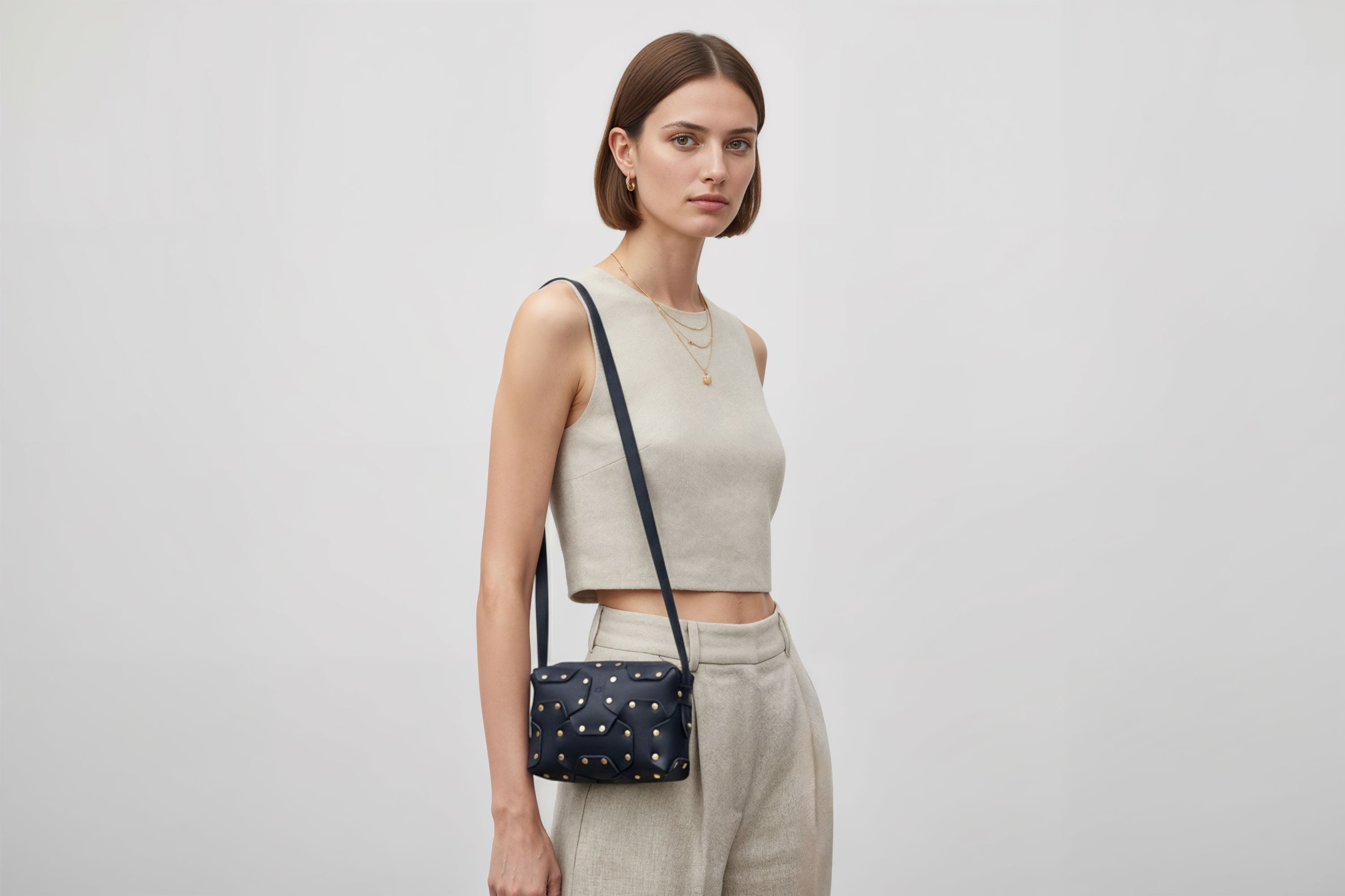 Double Rivet Bag Blue Color On A Woman Model Leather Full Grain Vegetable Tanned Leather Modern Minimalist Design Premium Quality Full Brass Clutch Crossbody Shoulder Bag Atelier Madre Manuel Dreesmann Barcelona Spain