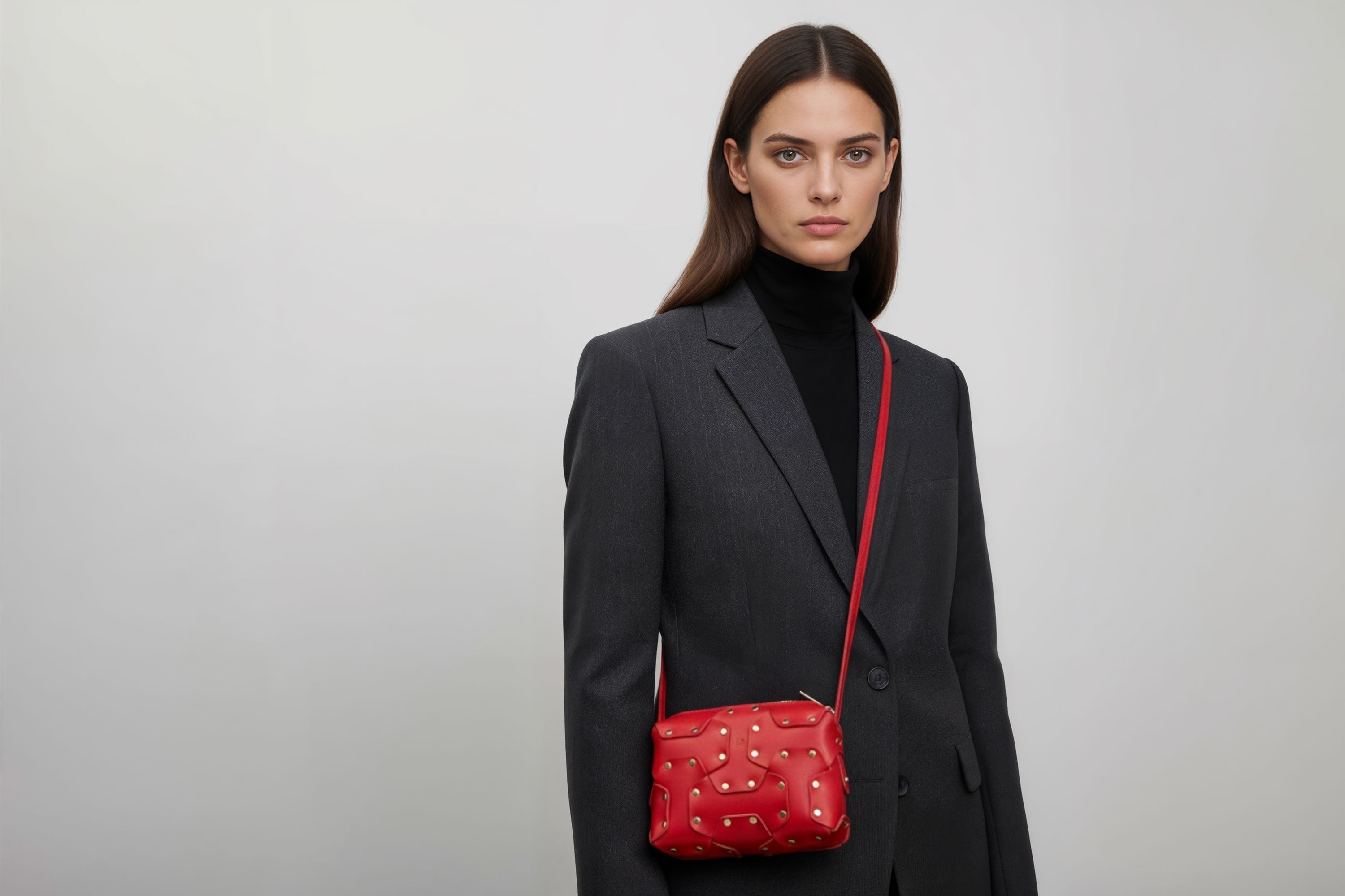 Double Rivet Bag Red Color On A Woman Model Leather Full Grain Vegetable Tanned Leather Modern Minimalist Design Premium Quality Full Brass Clutch Crossbody Shoulder Bag Atelier Madre Manuel Dreesmann Barcelona Spain