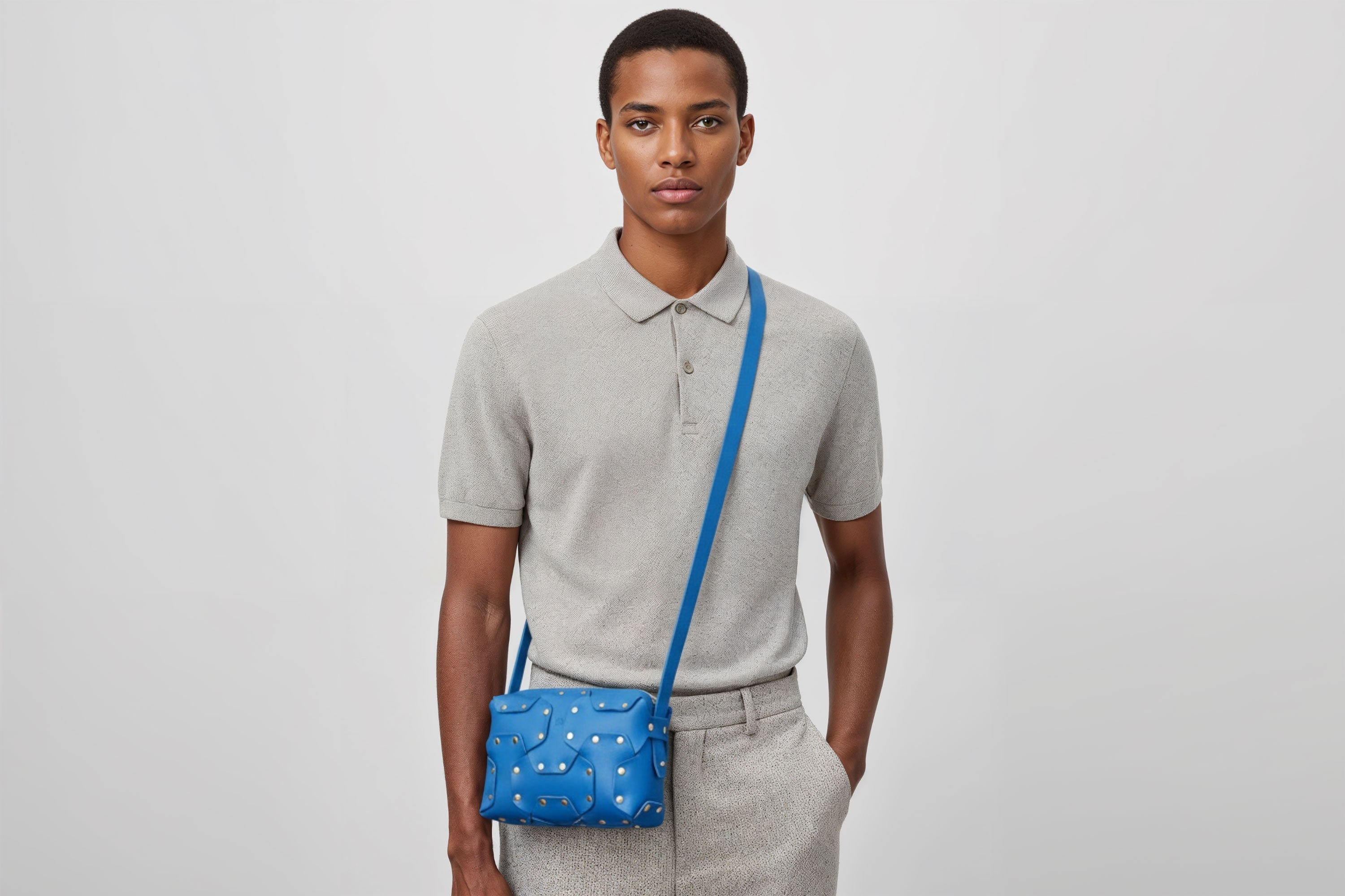 Double Rivet Bag Royal Blue Color On A Man Model Leather Full Grain Vegetable Tanned Leather Modern Minimalist Design Premium Quality Full Brass Clutch Crossbody Shoulder Bag Atelier Madre Manuel Dreesmann Barcelona Spain