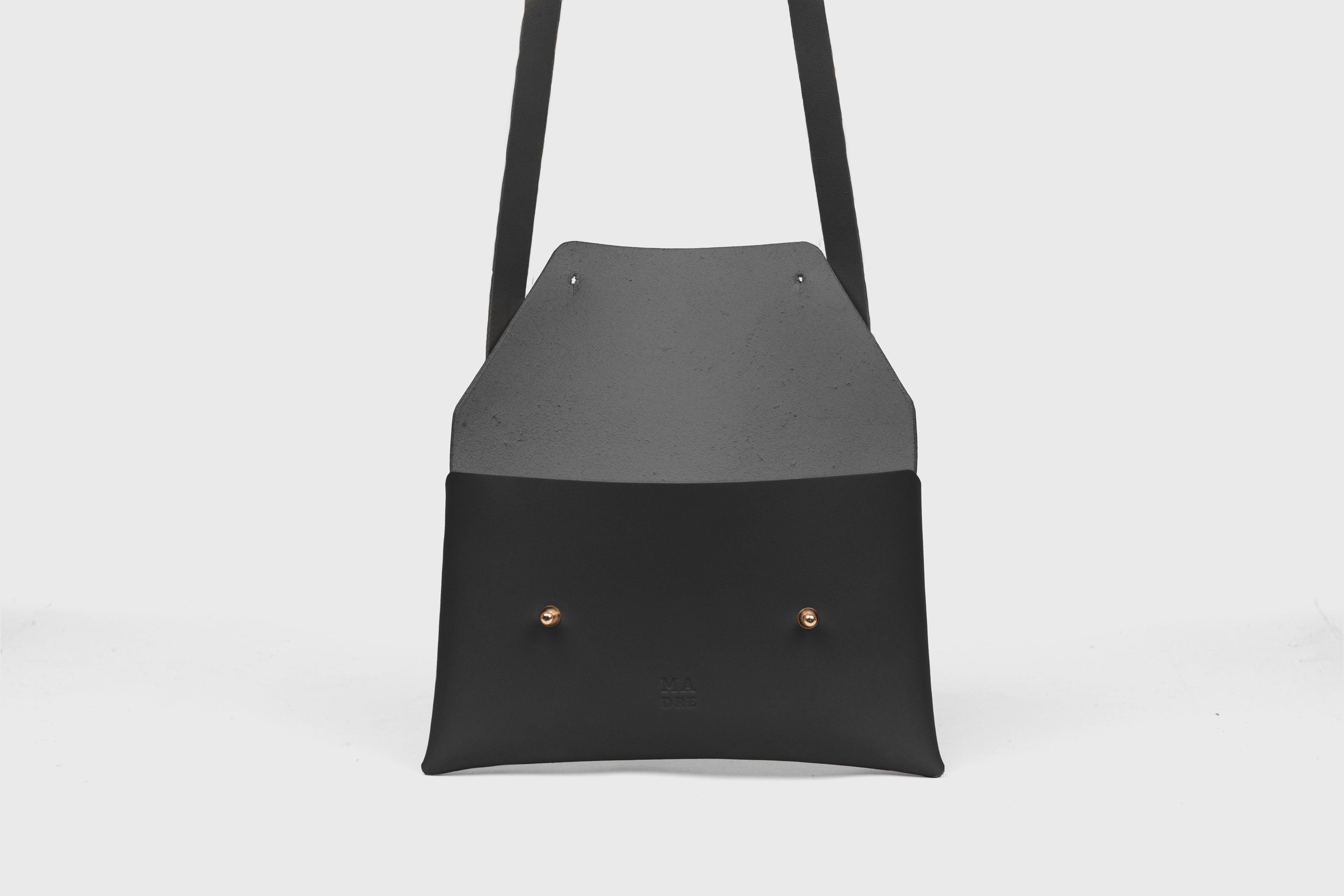 Envelope Bag With a Strap In Black Color Vegetable Tanned Leather Minimalistic Design Atelier Madre Manuel Dreesmann Barcelona Spain