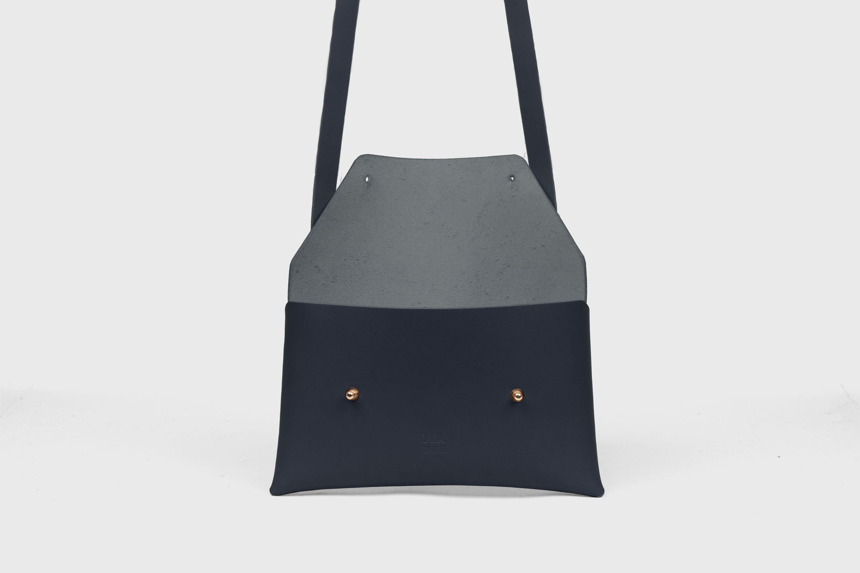 Envelope Bag With a Strap In Marine Blue Color Vegetable Tanned Leather Minimalistic Design Atelier Madre Manuel Dreesmann Barcelona Spain