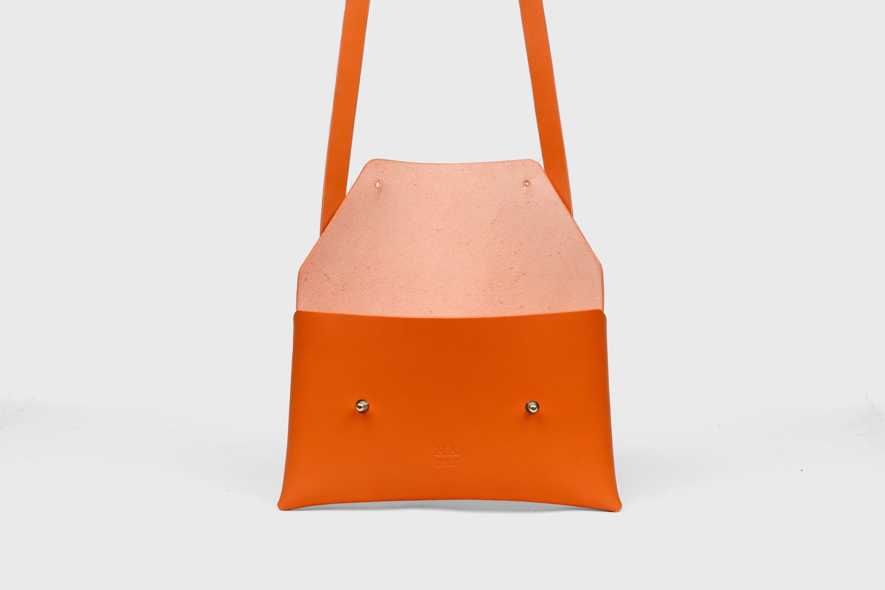 Envelope Bag With a Strap In Orange Color Vegetable Tanned Leather Minimalistic Design Atelier Madre Manuel Dreesmann Barcelona Spain