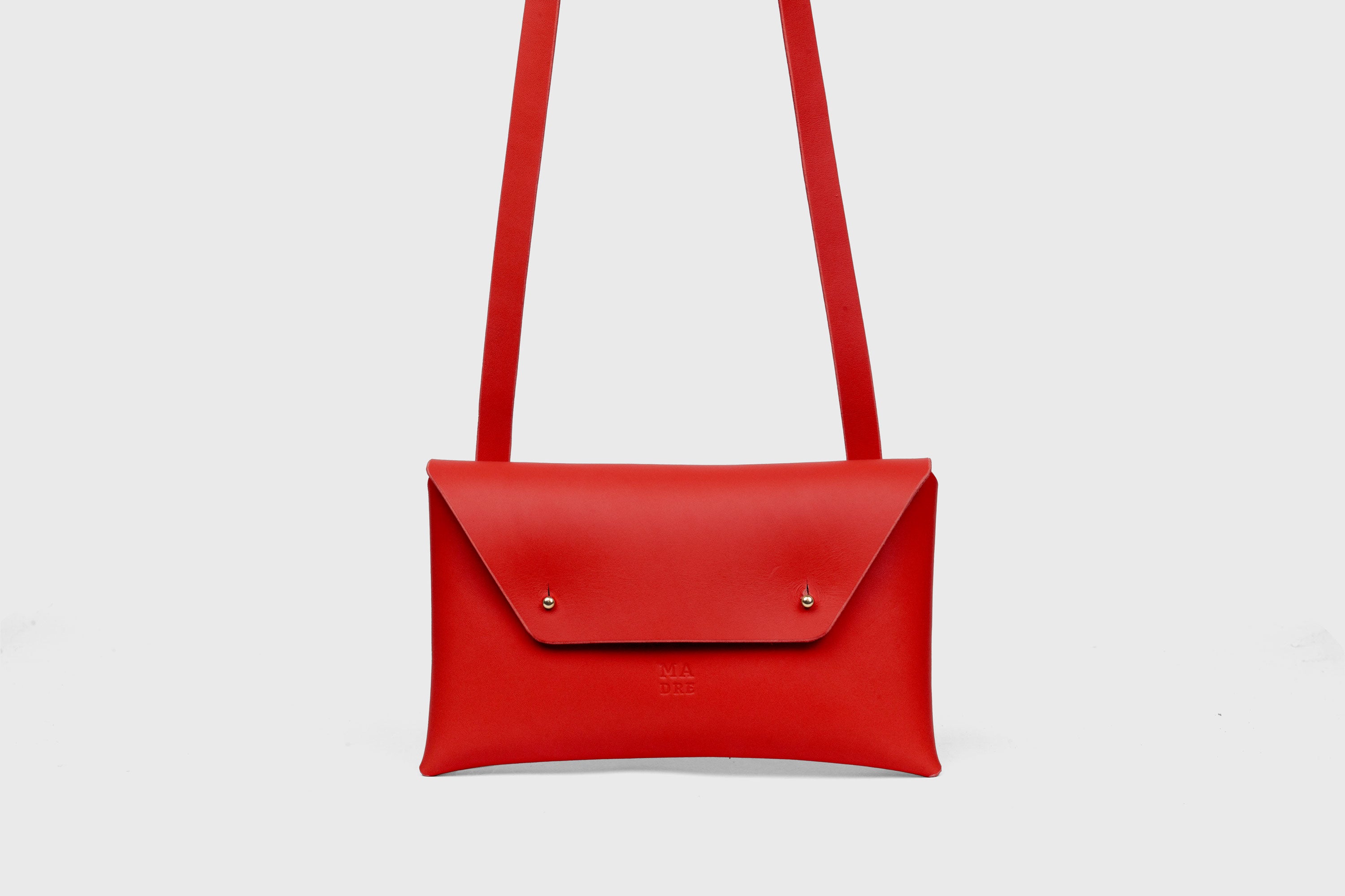 Envelope Bag With a Strap In Red Color Vegetable Tanned Leather Minimalistic Design Atelier Madre Manuel Dreesmann Barcelona Spain