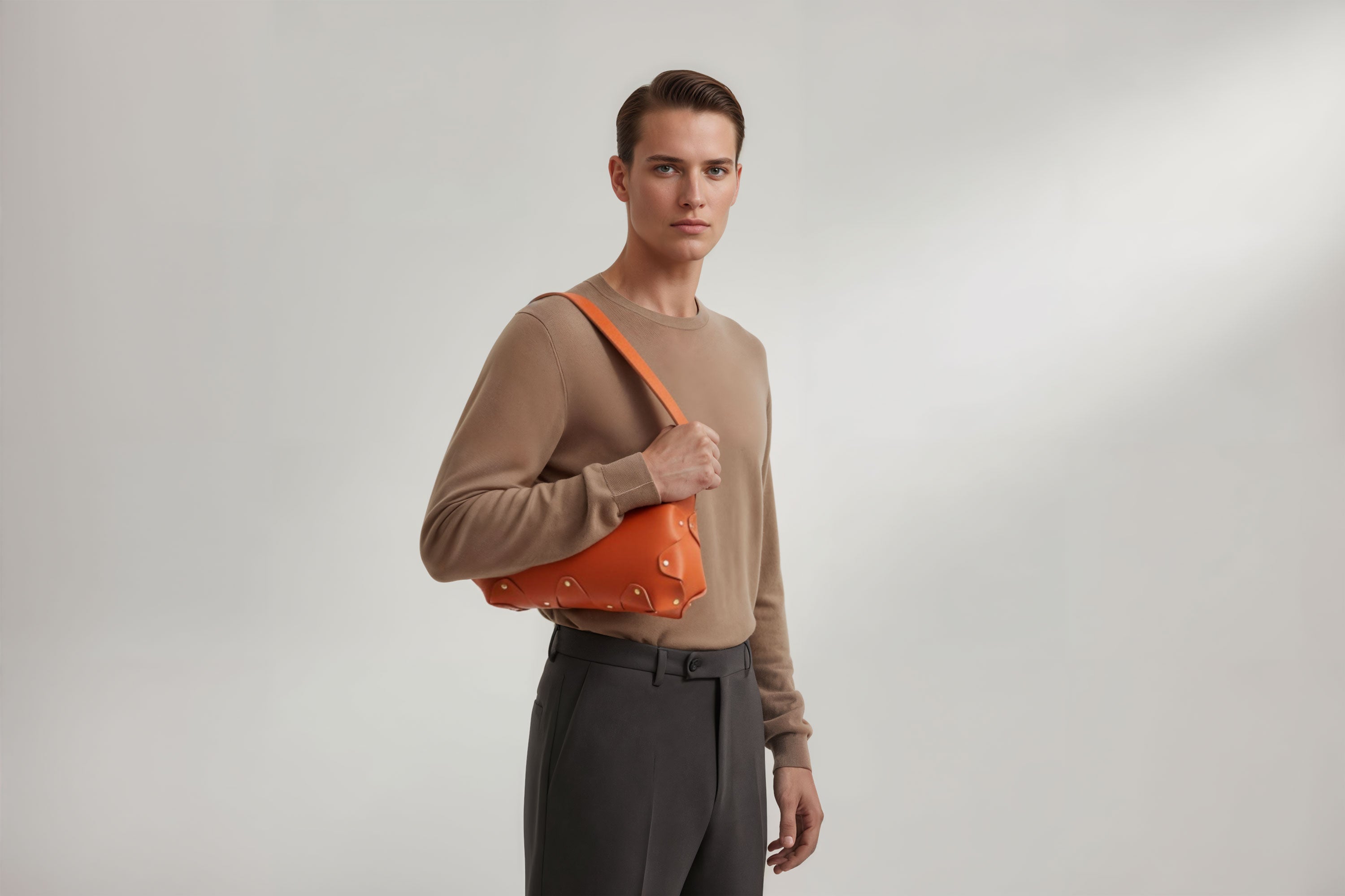 Fiona Bag Orange Colour Leather On Man Model Bright Background Vegetable Tanned Leather Modern Minimalist Design Premium Quality Atelier Madre Manuel Dreesmann Barcelona Spain