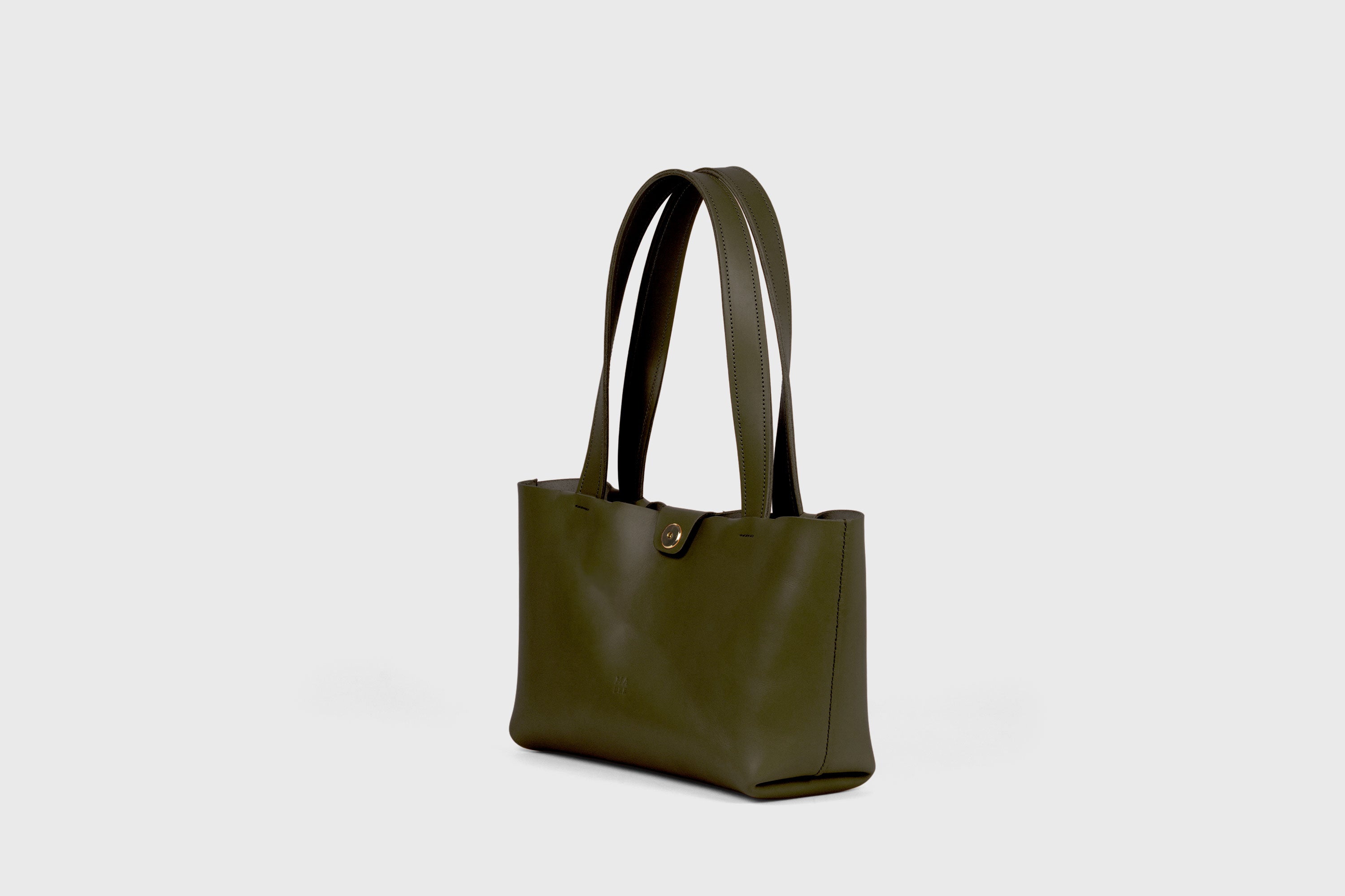 Karin Bag Closure In Olive Green Color In Vegetable Tanned Leather Magnetic Closure Open Top Minimalistic Design Barcelona Spain