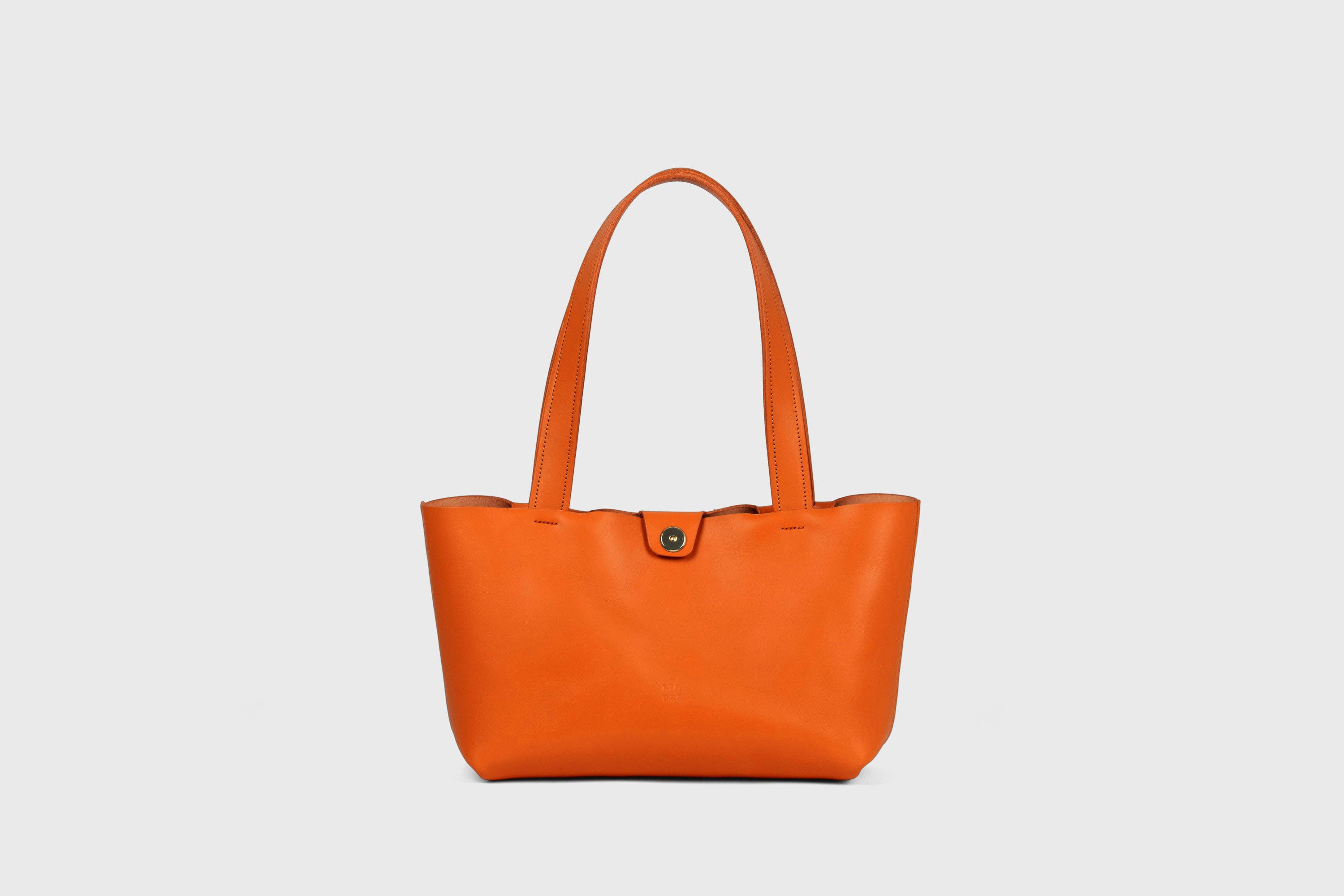 Karin Bag Closure In Orange Color In Vegetable Tanned Leather Magnetic Closure Open Top Minimalistic Design Barcelona Spain