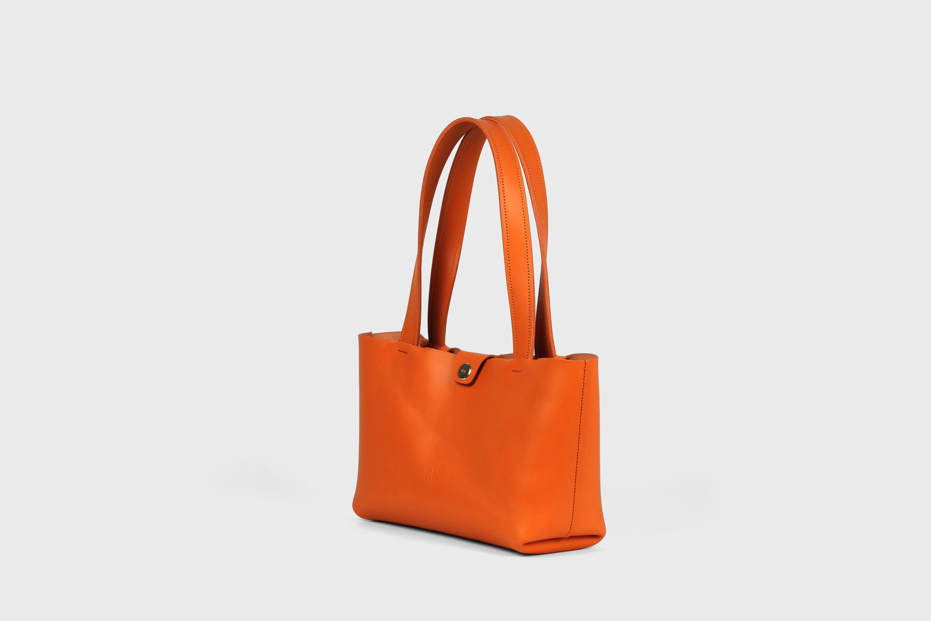Karin Bag Closure In Orange Color In Vegetable Tanned Leather Magnetic Closure Open Top Minimalistic Design Barcelona Spain