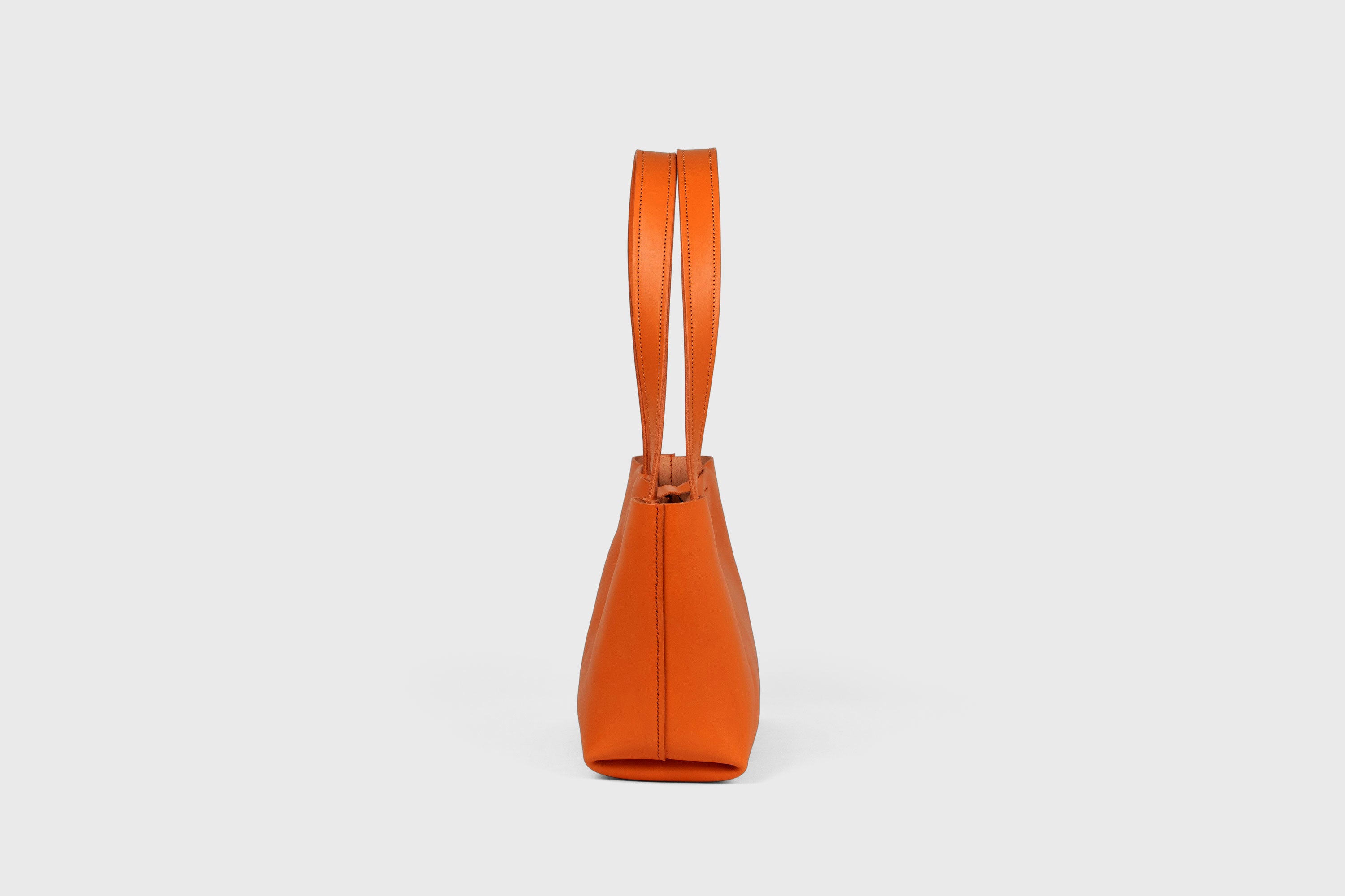 Karin Bag Closure In Orange Color In Vegetable Tanned Leather Magnetic Closure Open Top Minimalistic Design Barcelona Spain
