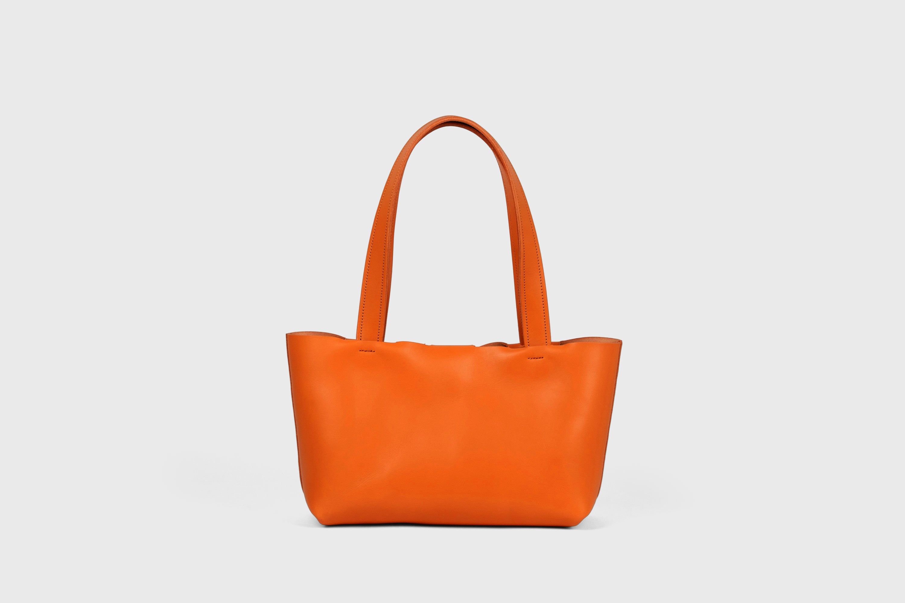 Karin Bag Closure In Orange Color In Vegetable Tanned Leather Magnetic Closure Open Top Minimalistic Design Barcelona Spain