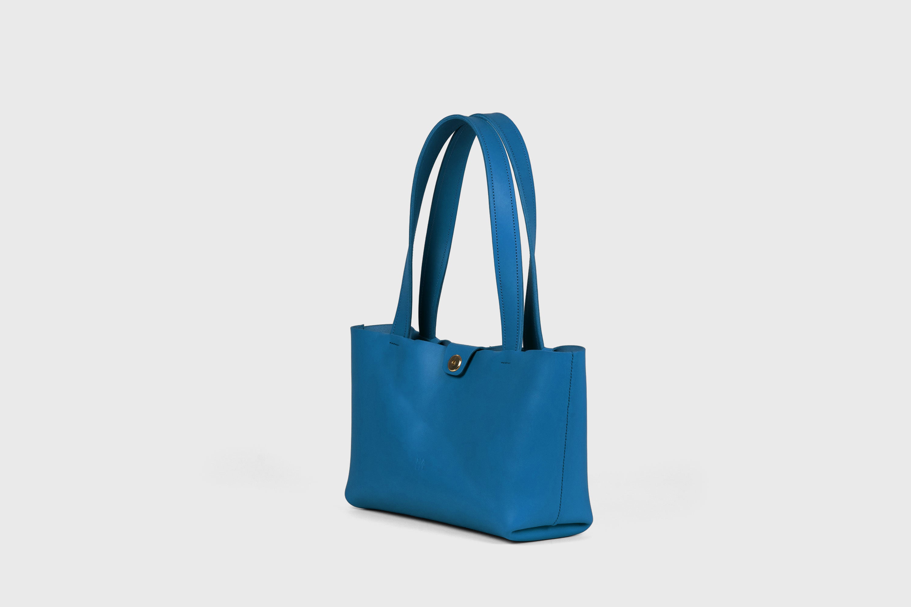 Karin Bag Closure In Royal Blue Color In Vegetable Tanned Leather Magnetic Closure Open Top Minimalistic Design Barcelona Spain