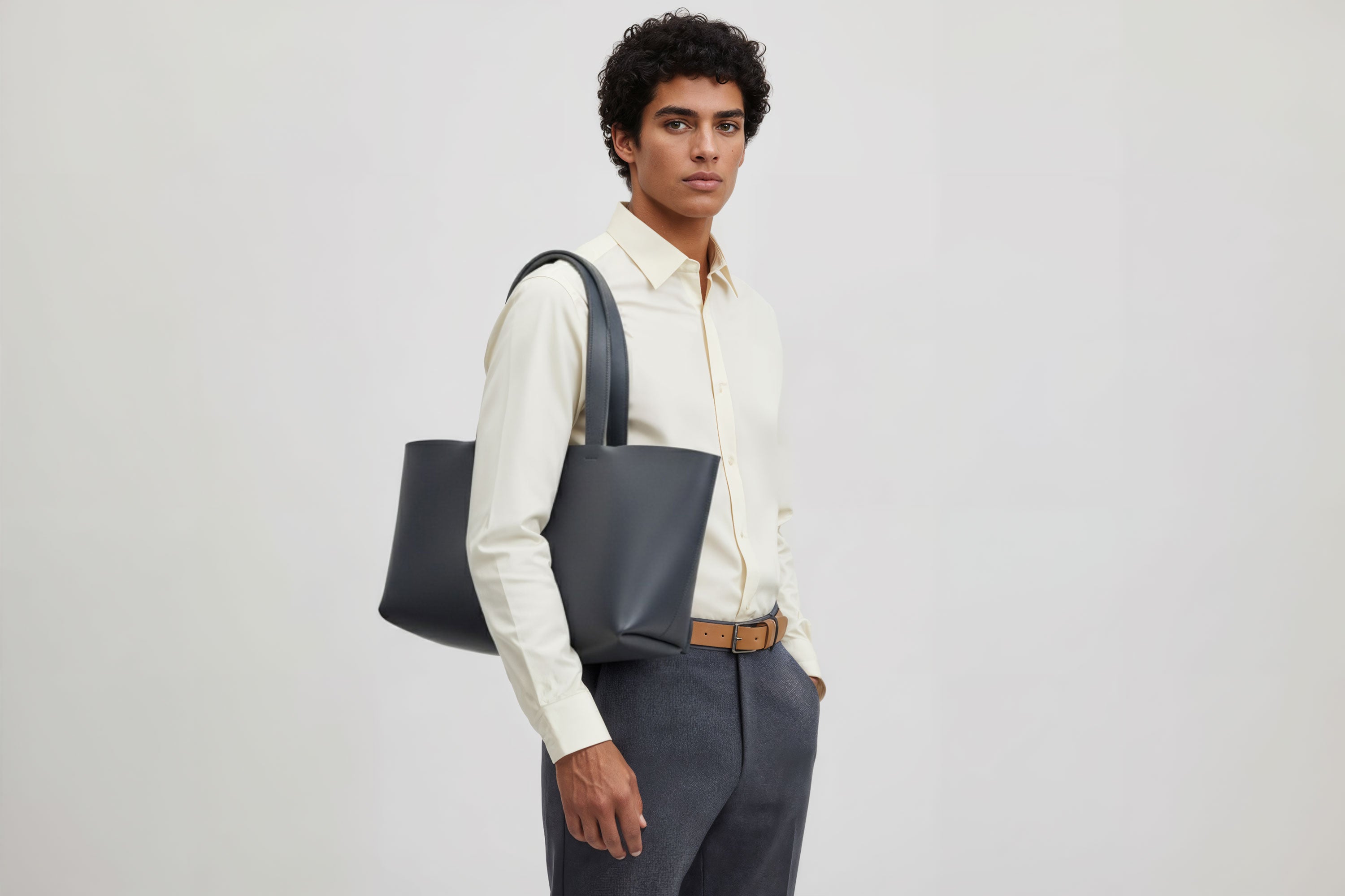 Karin Tote Bag Marine Blue Color On A Man Model Vegetable Tanned Leather Vachetta Minimalistic Design Premium Atelier Madre Manuel Dreesmann Barcelona Spain
