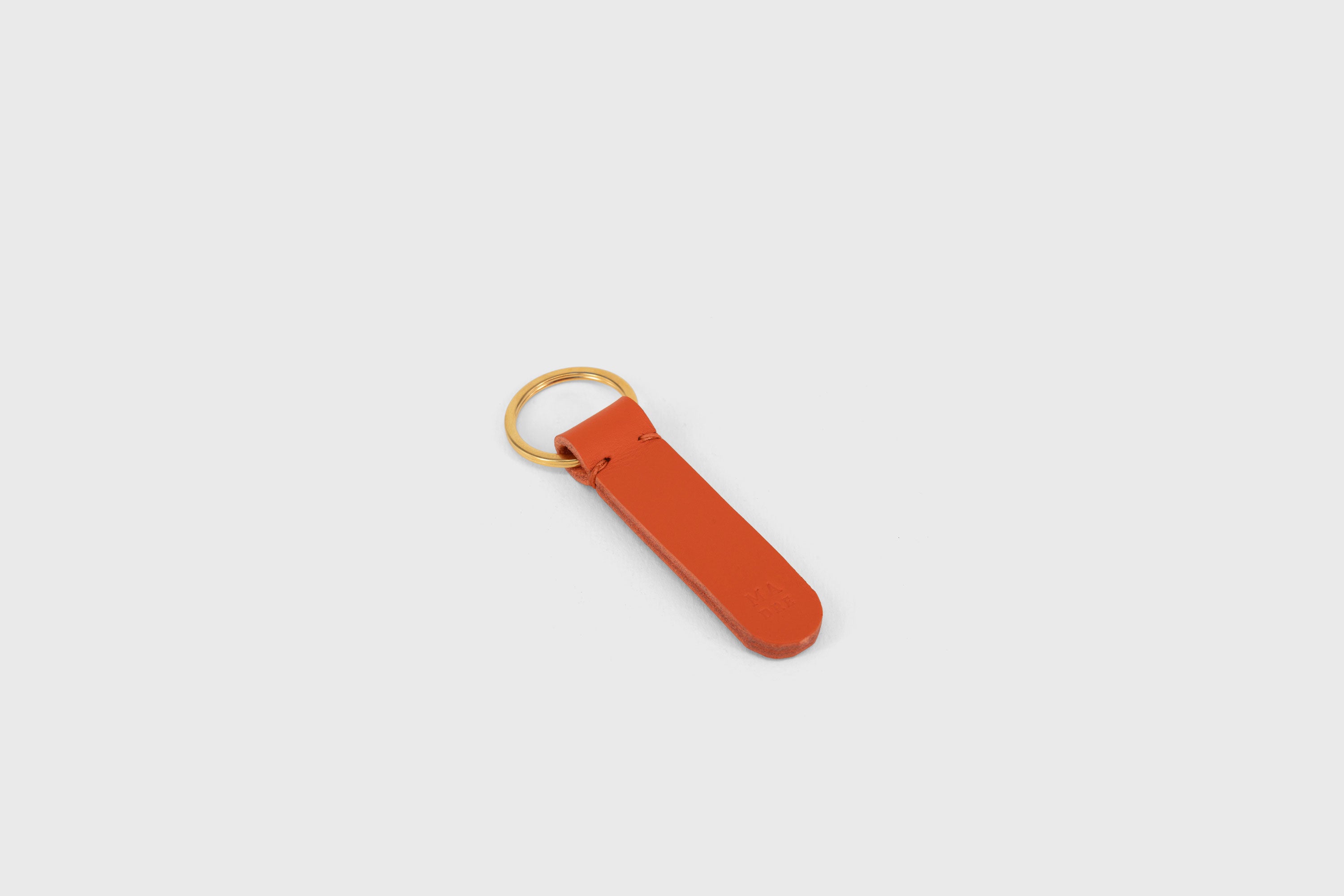 Key Ring Leather Orange Color Fob Minimalist Designer Vegetable Tanned Full Grain Handcrafted Personalised Premium Quality Gold Atelier Madre Manuel Dreesmann Barcelona Spain