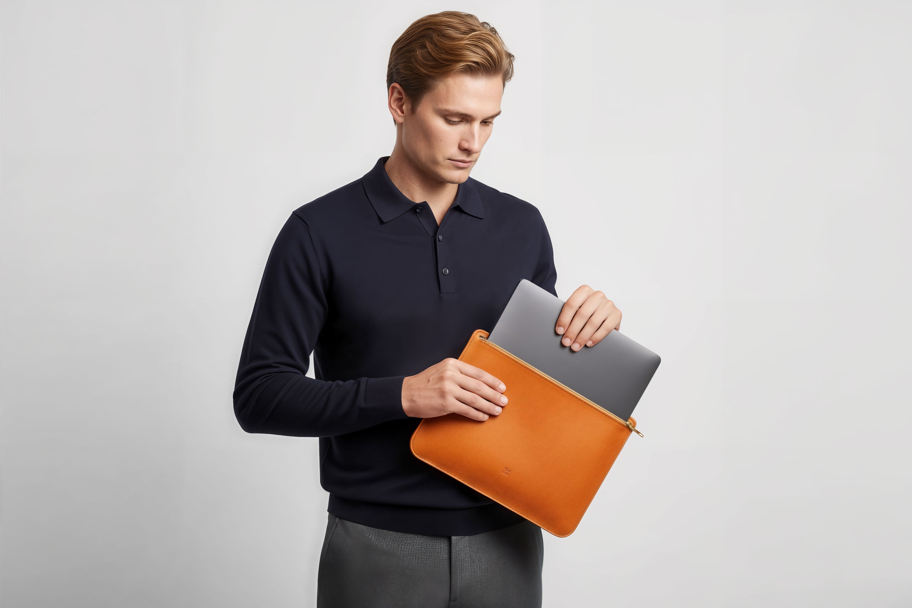 MacBook Sleeve Zipper Orange Leather Horizontal On Model Grey Background Minimalistic Premium Design Atelier Madre Manuel Dreesmann Barcelona