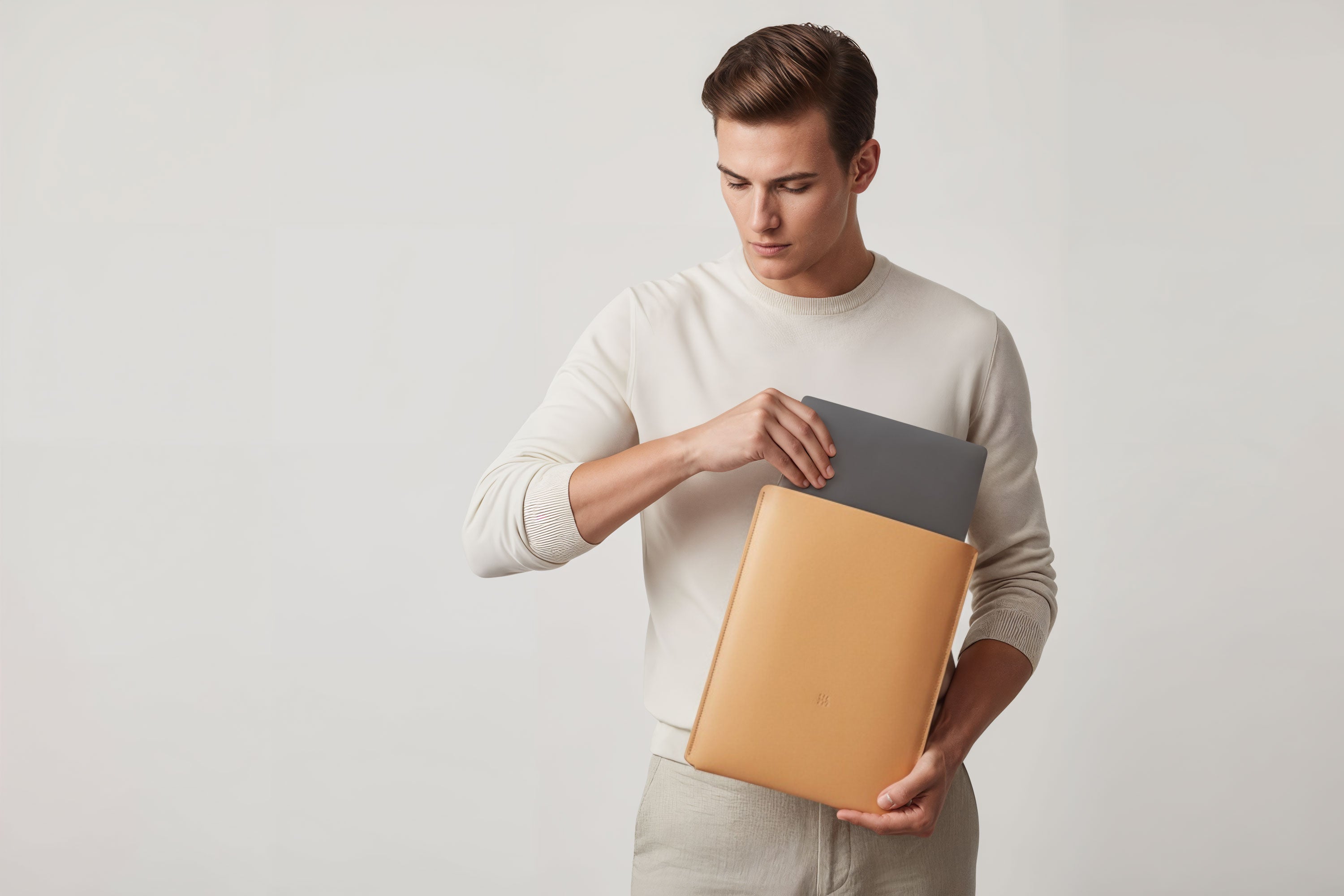 MacBook Slip Sleeve Natural Color Leather On Model Grey Background Minimalistic Premium Design Atelier Madre Manuel Dreesmann Barcelona