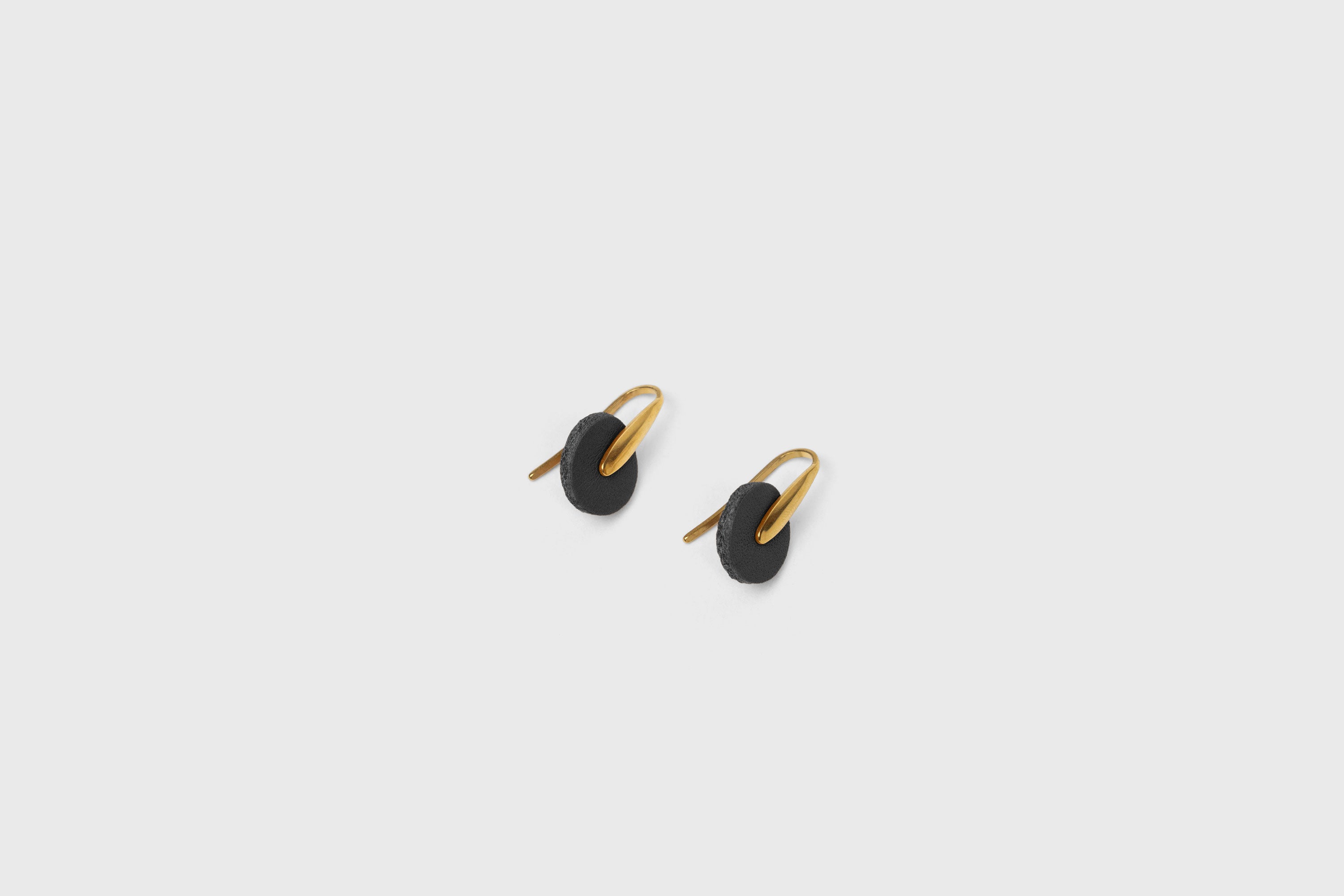 Lina Earrings In Black Color In Vegetable Tanned Leather Brass Hook Minimalistic Design Atelier Madre Manuel Dreesmann Barcelona Spain