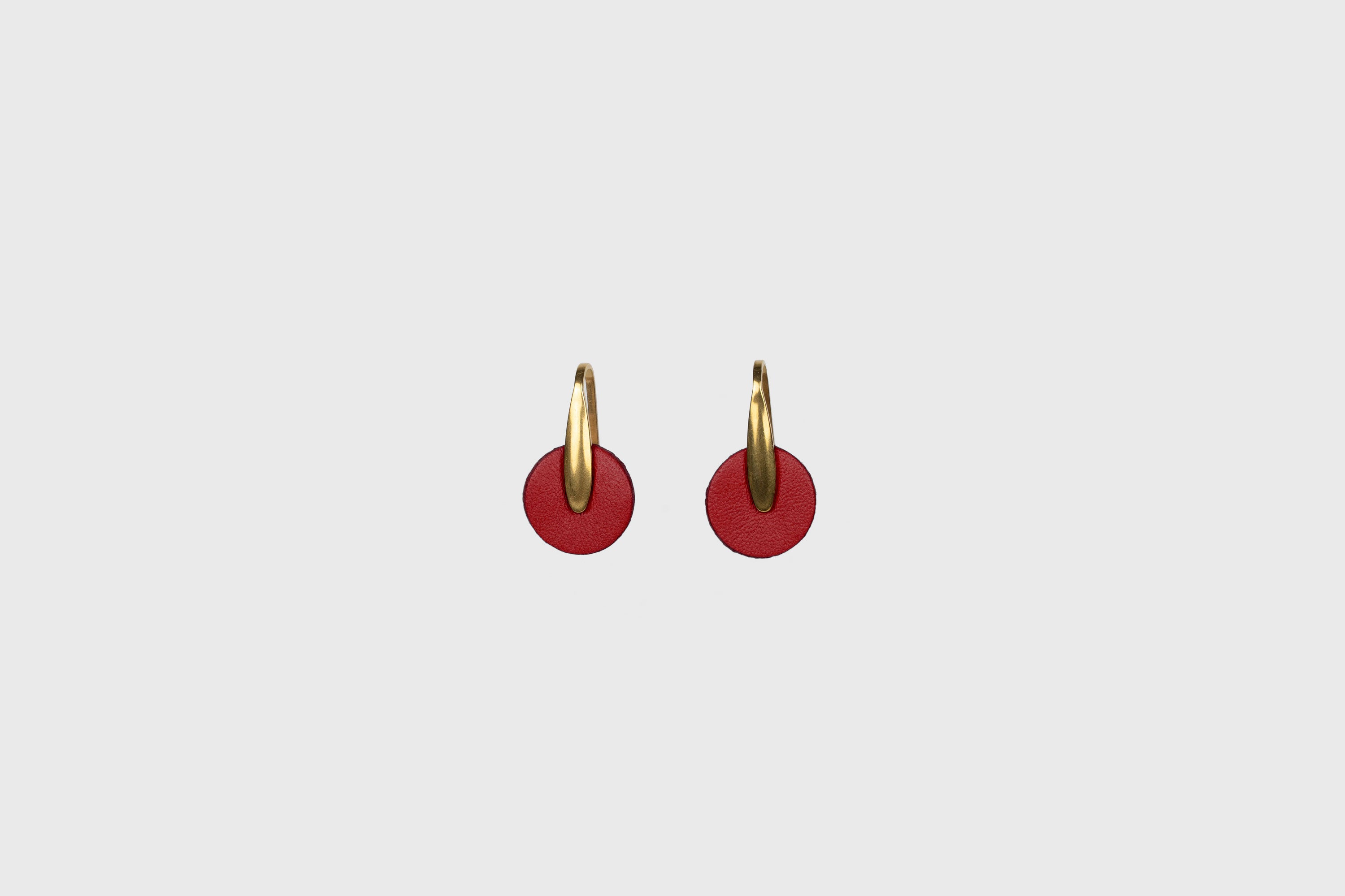 Lina Earrings In Red Color In Vegetable Tanned Leather Brass Hook Minimalistic Design Atelier Madre Manuel Dreesmann Barcelona Spain