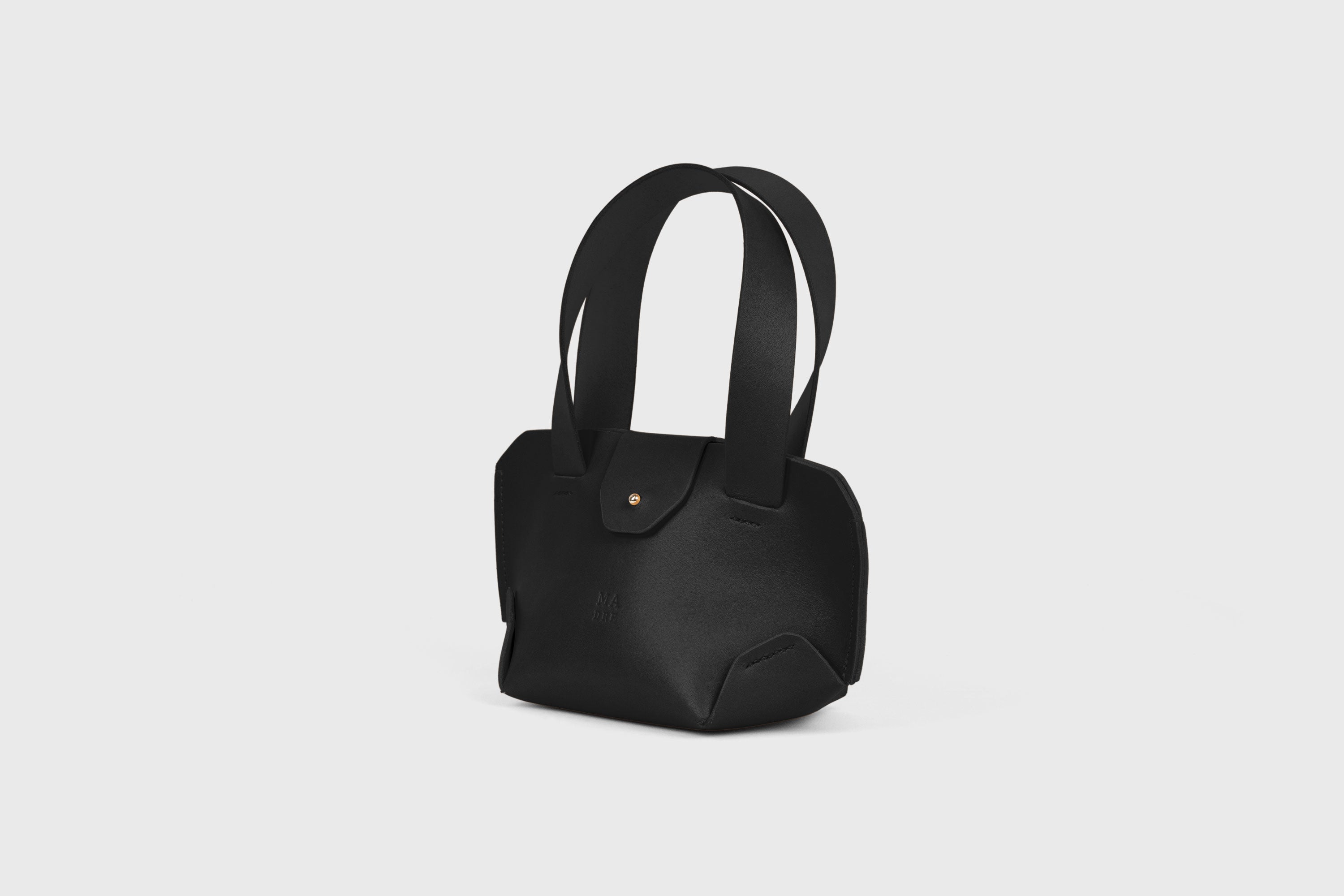 Mini Tote Bag In Black Color In Vegetable Tanned Leather Bag With A Flap In Minimalistic Design Atelier Madre Manuel Dreesmann 